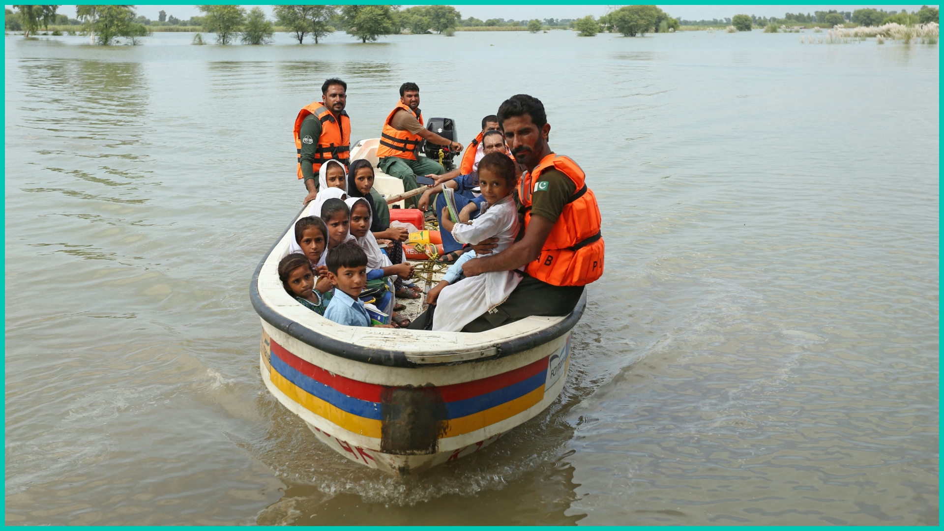  Rescue workers use a boat to drop children back home after school in a flood hit area following heavy monsoon rains in Dera Ghazi Khan district in Punjab province on August 29, 2022.
