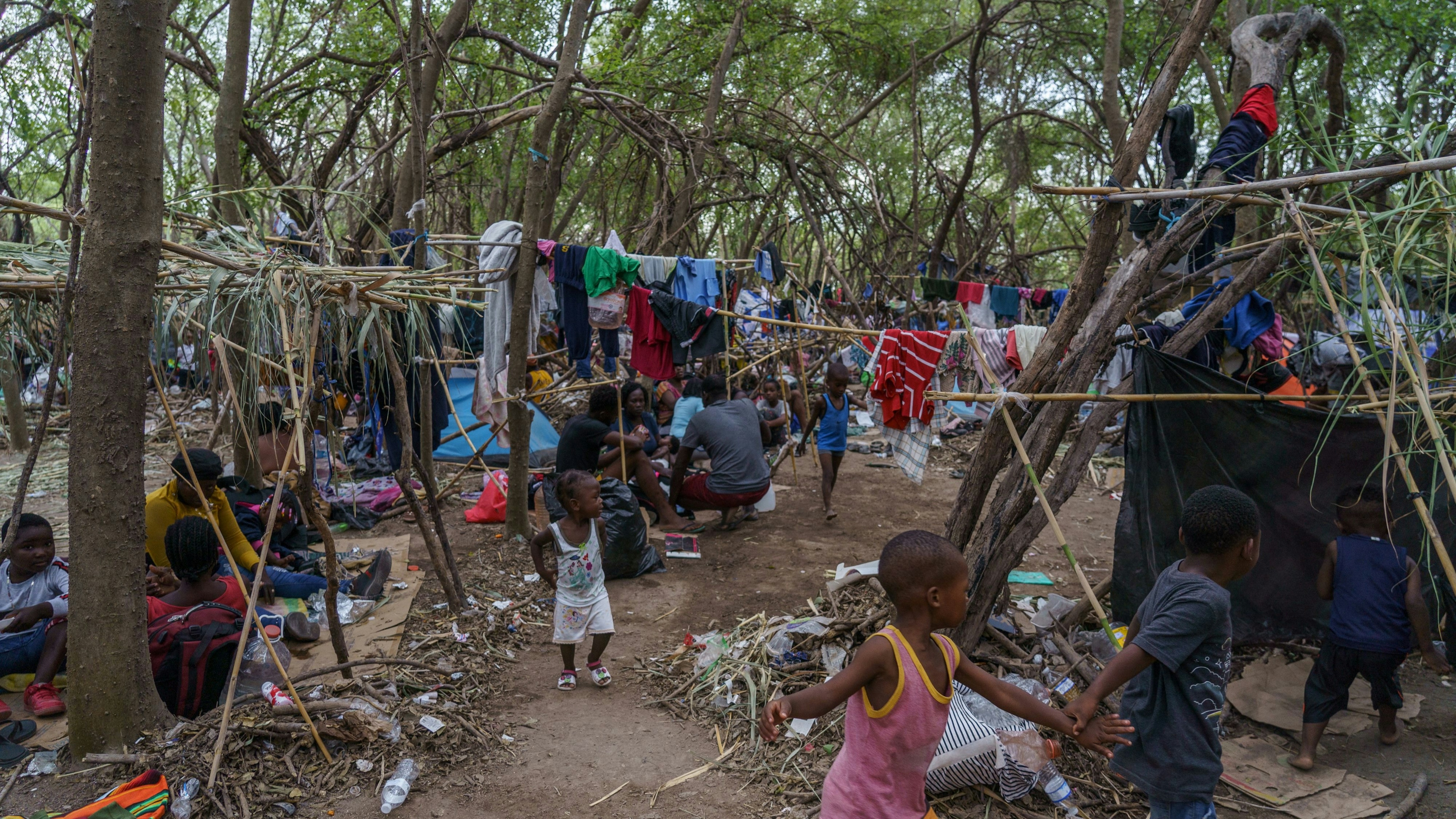 Haitian migrants are pictured in a makeshift encampment where more than 12,000 people hoping to enter the United States await under the international bridge in Del Rio, Texas