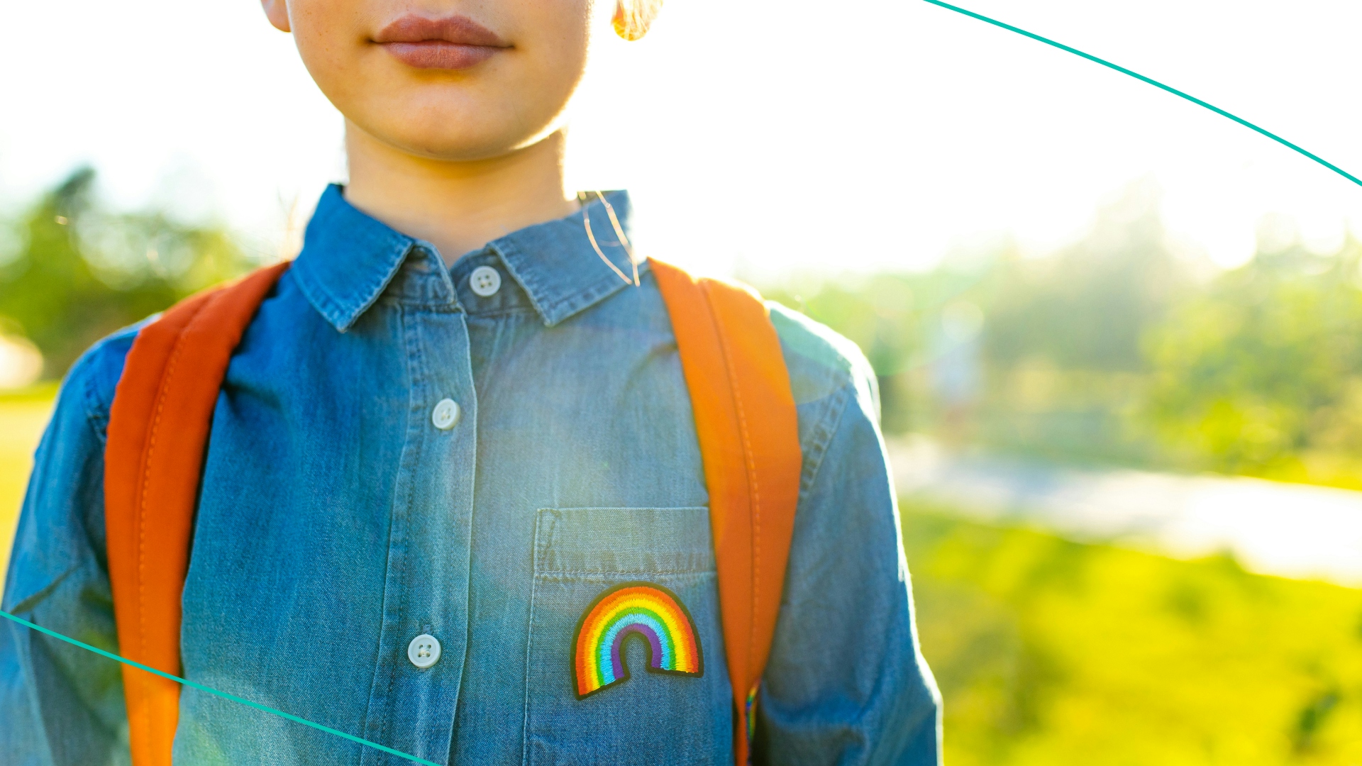 Young boy wearing a rainbow flag patch on his shirt
