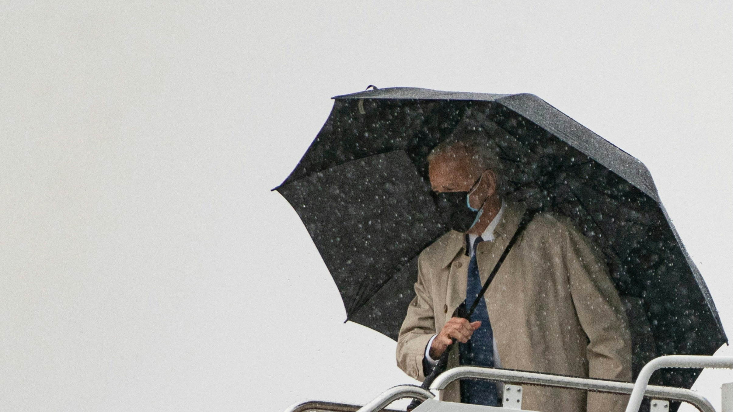 US President Joe Biden boards Air Force One in the rain at Andrews Air Force Base on March 31, 2021 in Maryland.
