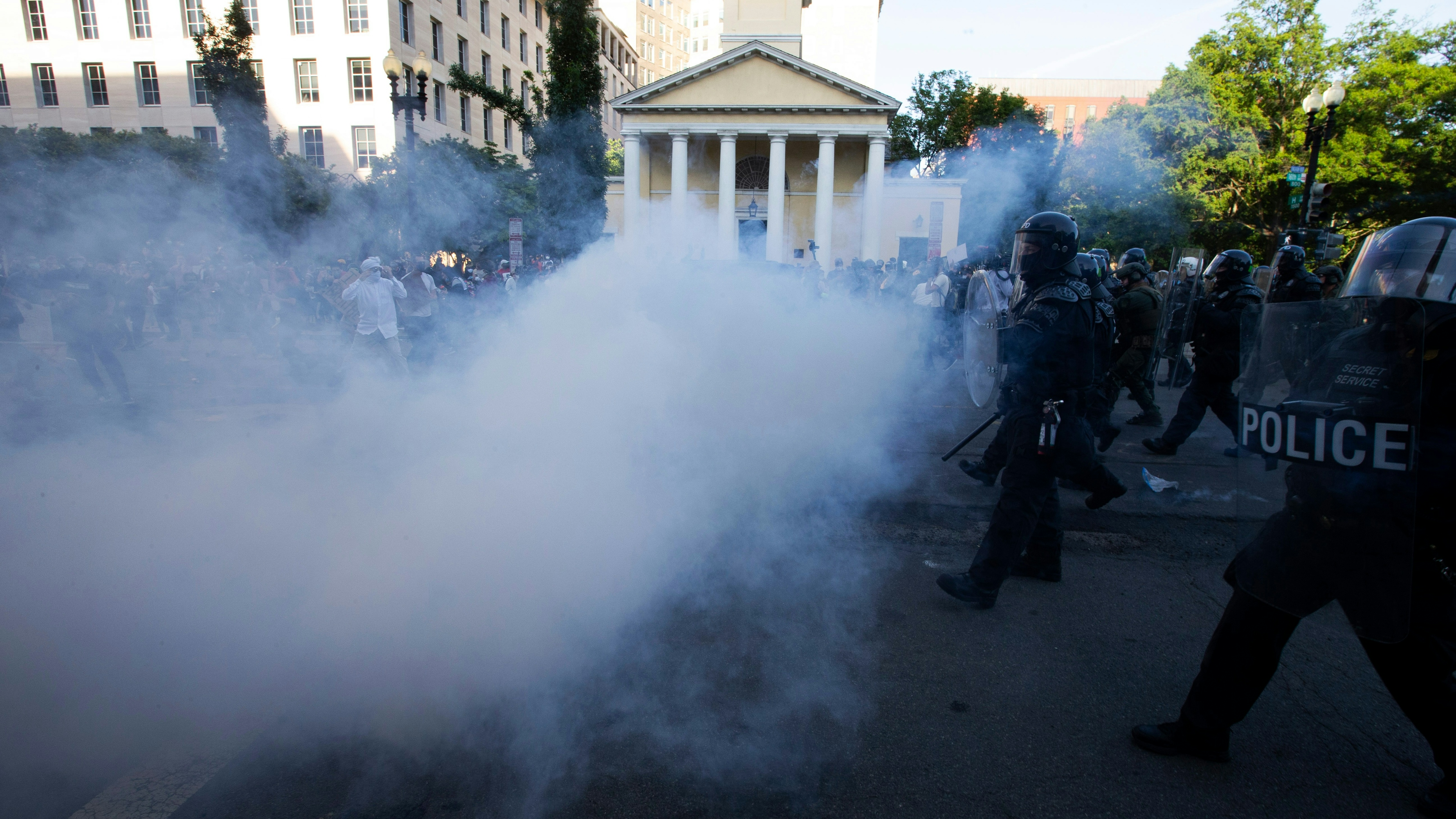 Police officers wearing riot gear push back demonstrators shooting tear gas next to St. John's Episcopal Church outside of the White House on June 1, 2020.