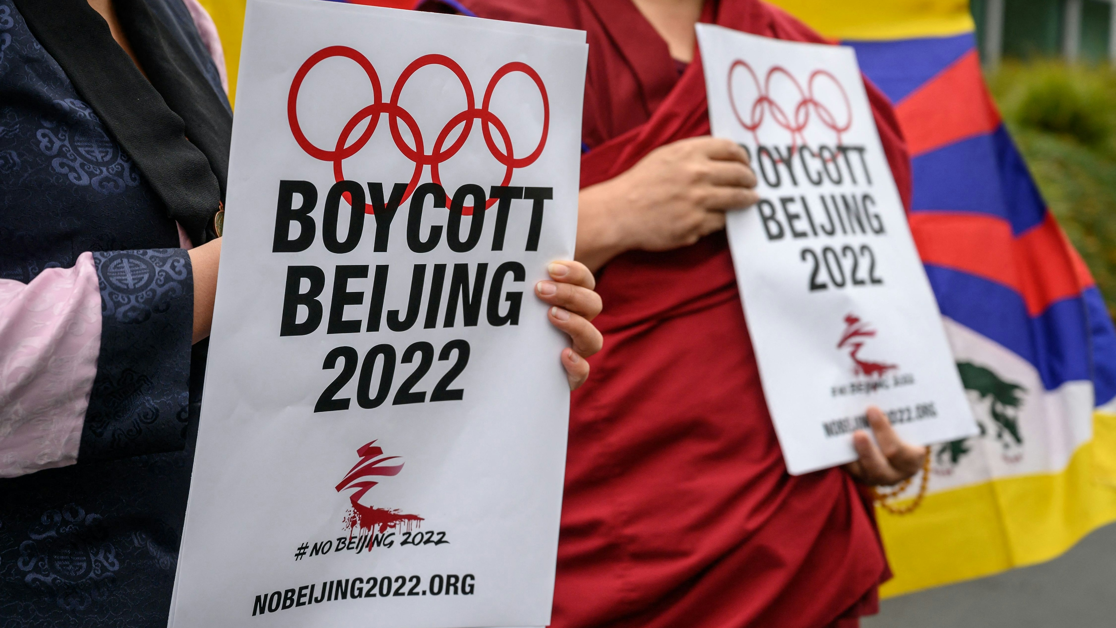 Tibetan activists stand in front of the International Olympic Committee (IOC) headquarters during a protest ahead of the February's Beijing 2022 Winter Olympics
