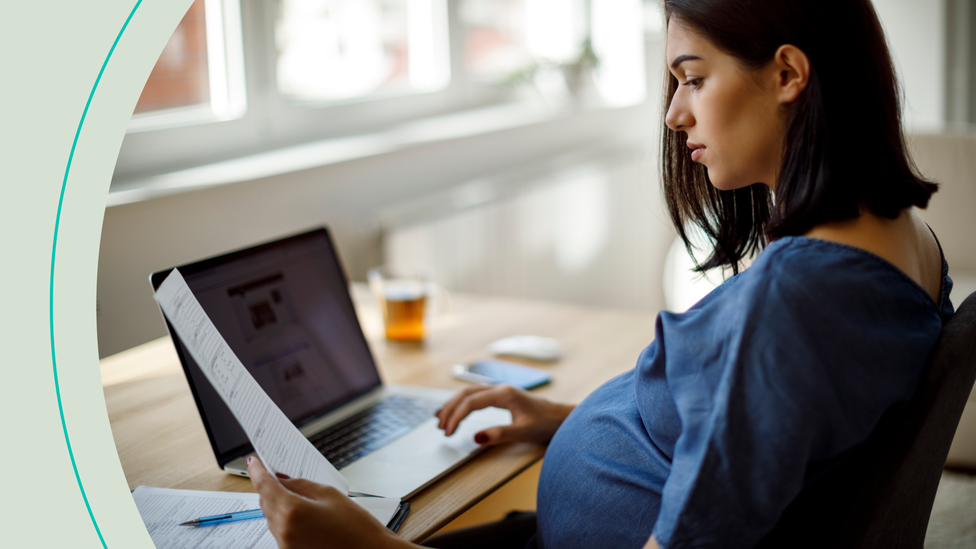 Pregnant woman looking at document 