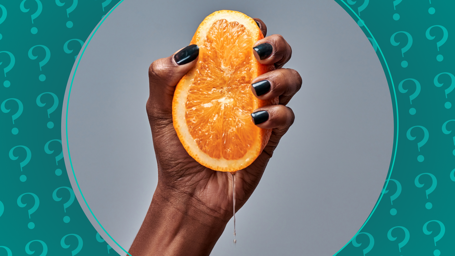 Woman's hand squeezing the juice from an orange