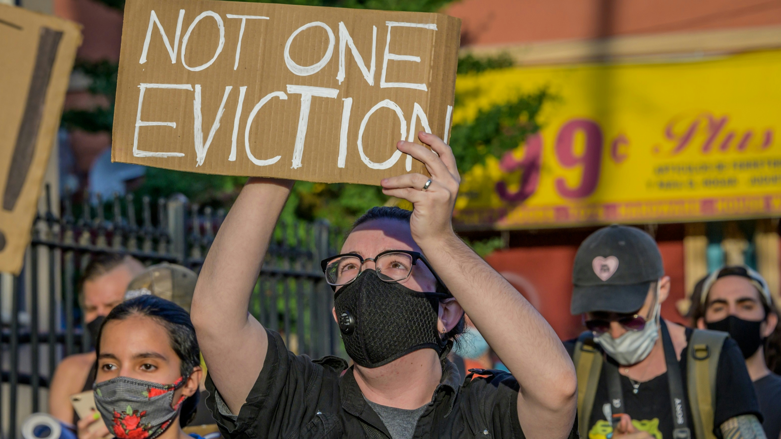 A participant holding a Not One Eviction sign at the protest