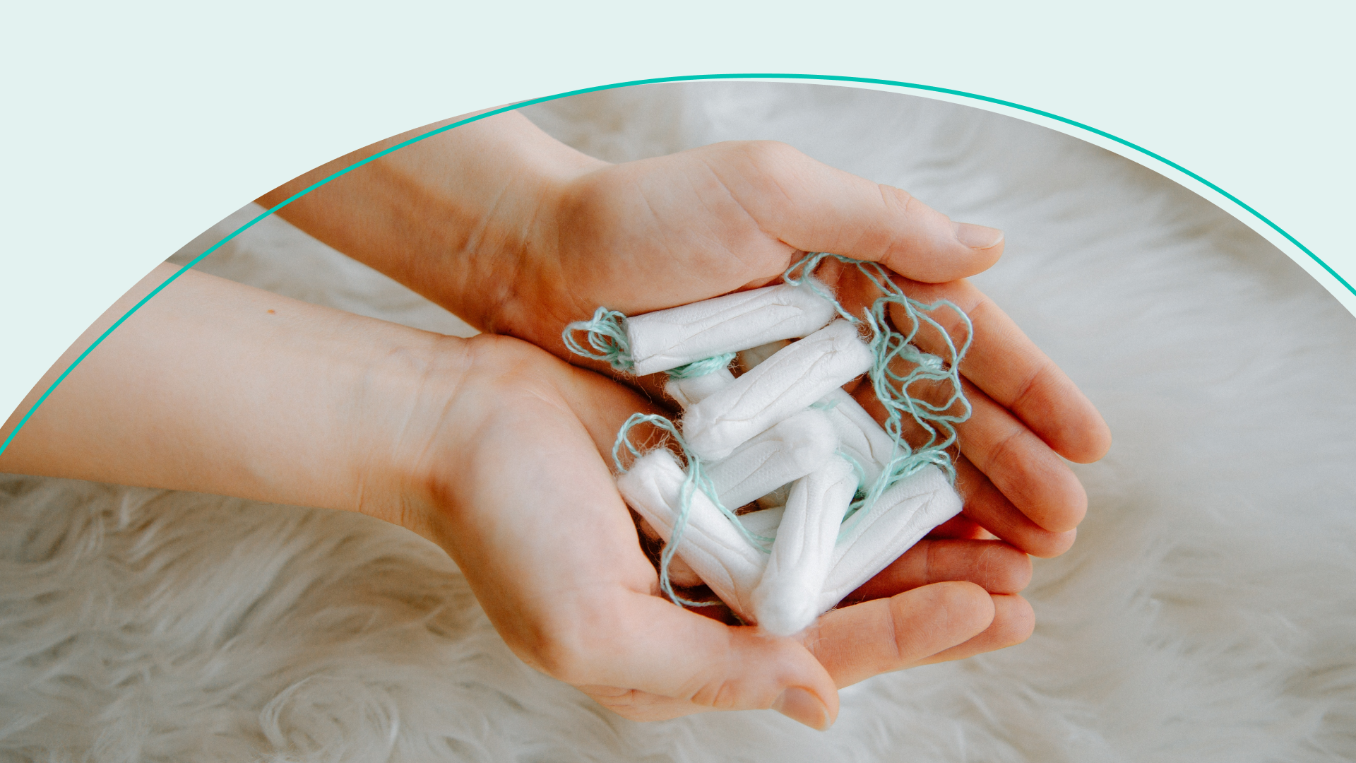 Person holding a handful of tampons