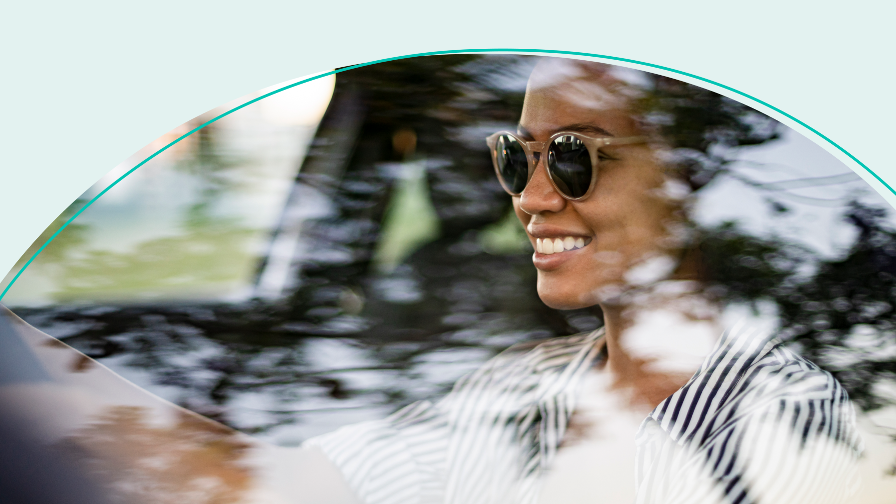 Women wearing sunglasses driving car with teal detail