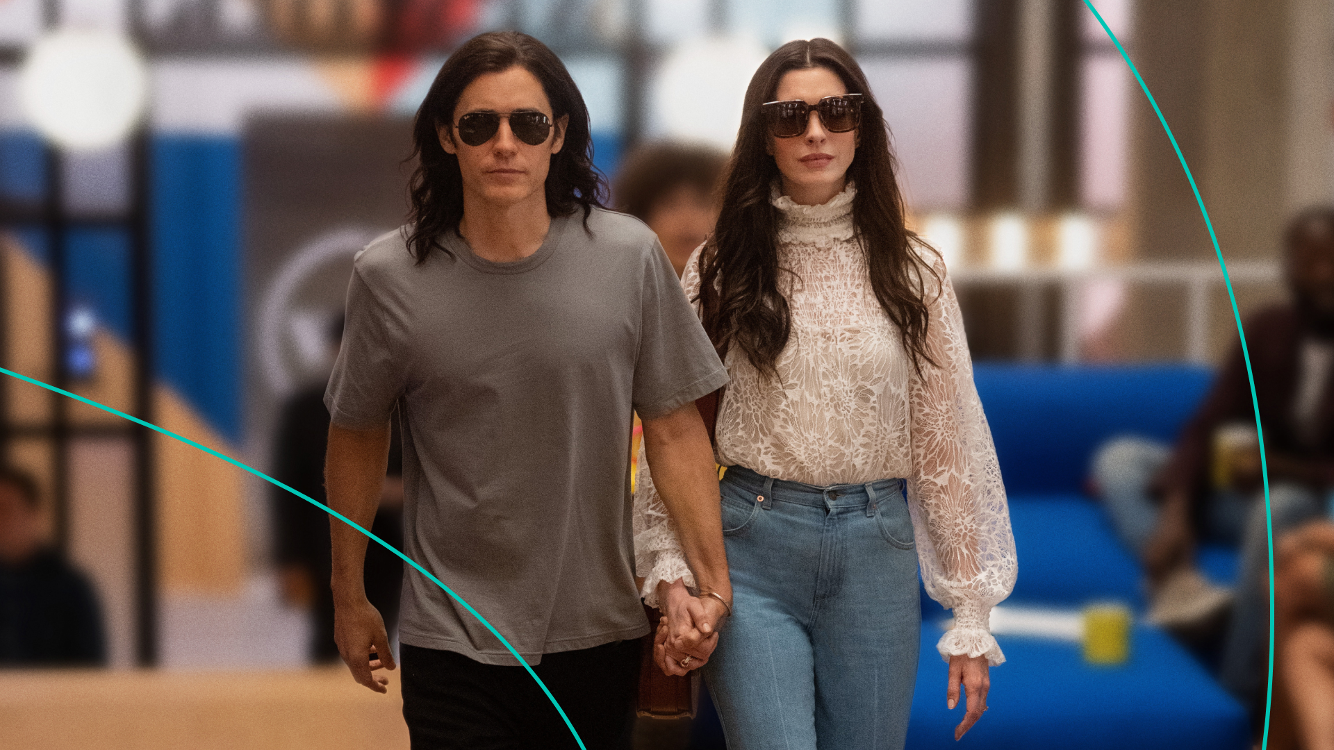 Jared Leto and Anne Hathaway walking and holding hands. 