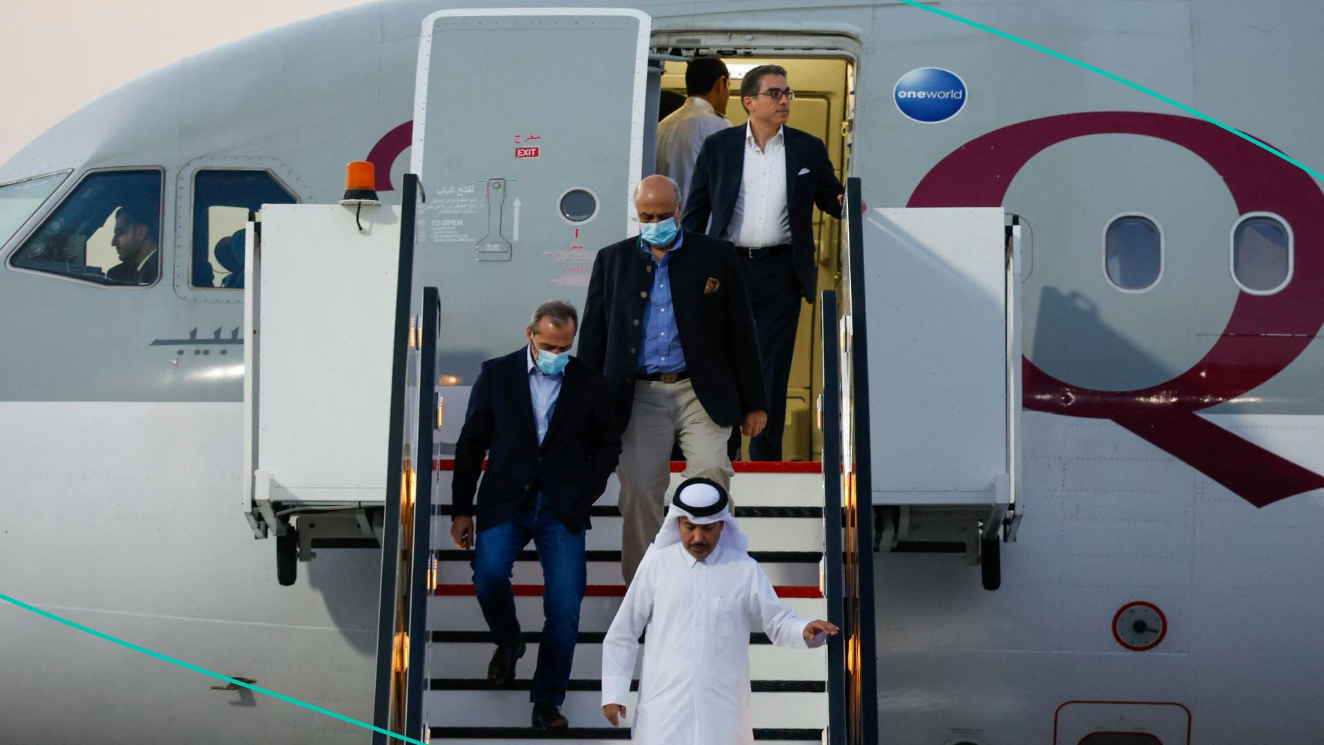US citizens Siamak Namazi (back), Emad Sharqi (L) and Morad Tahbaz (C) disembark from a Qatari jet upon their arrival at the Doha International Airport