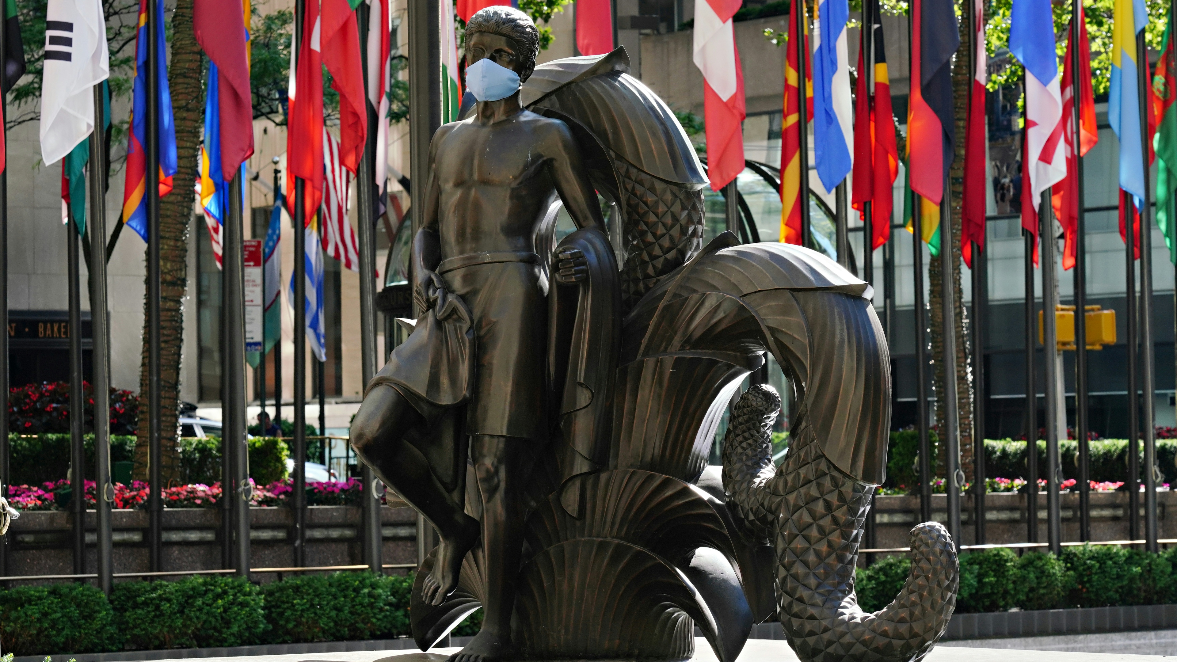 Paul Manship's 'Youth' statue in Rockefeller Center wears a mask to coincide with New York City moving into the phase two re-opening from the coronavirus pandemic.