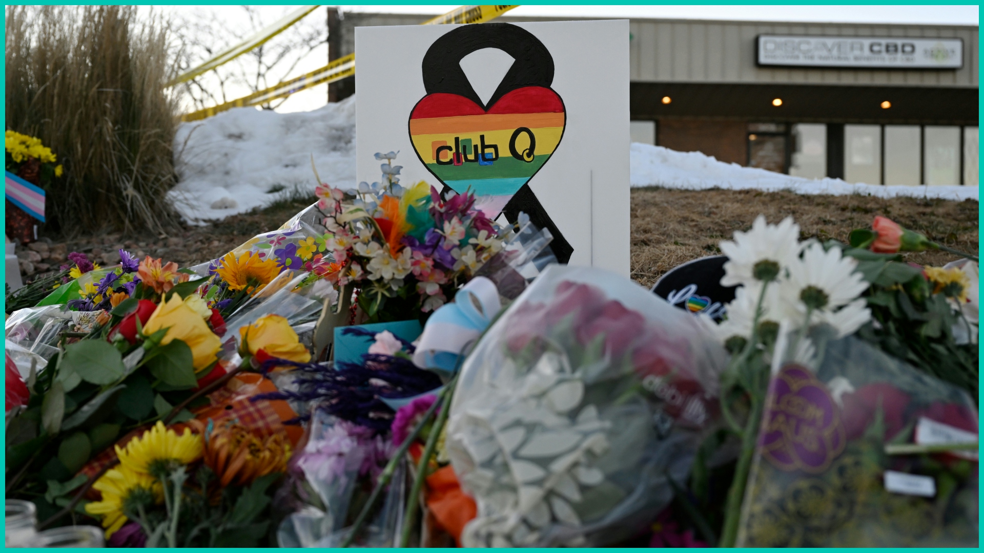 People leaves flowers and other items at a memorial near Club Q 