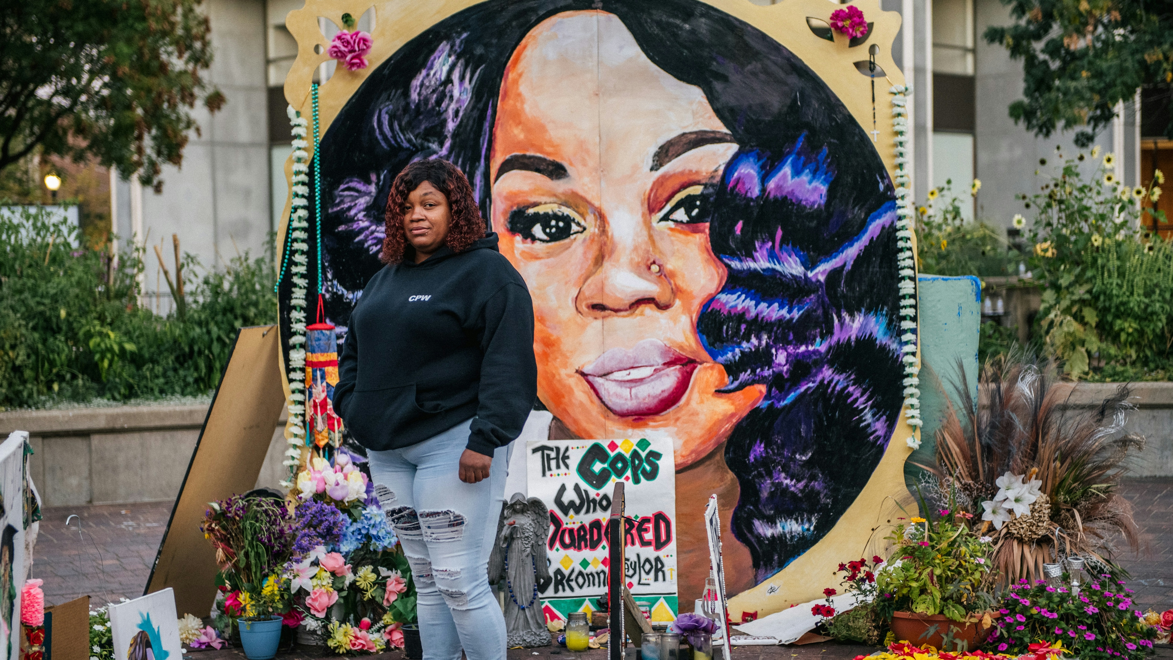 Tamika Palmer, mother of Breonna Taylor, poses for a portrait in front of a mural of her daughter