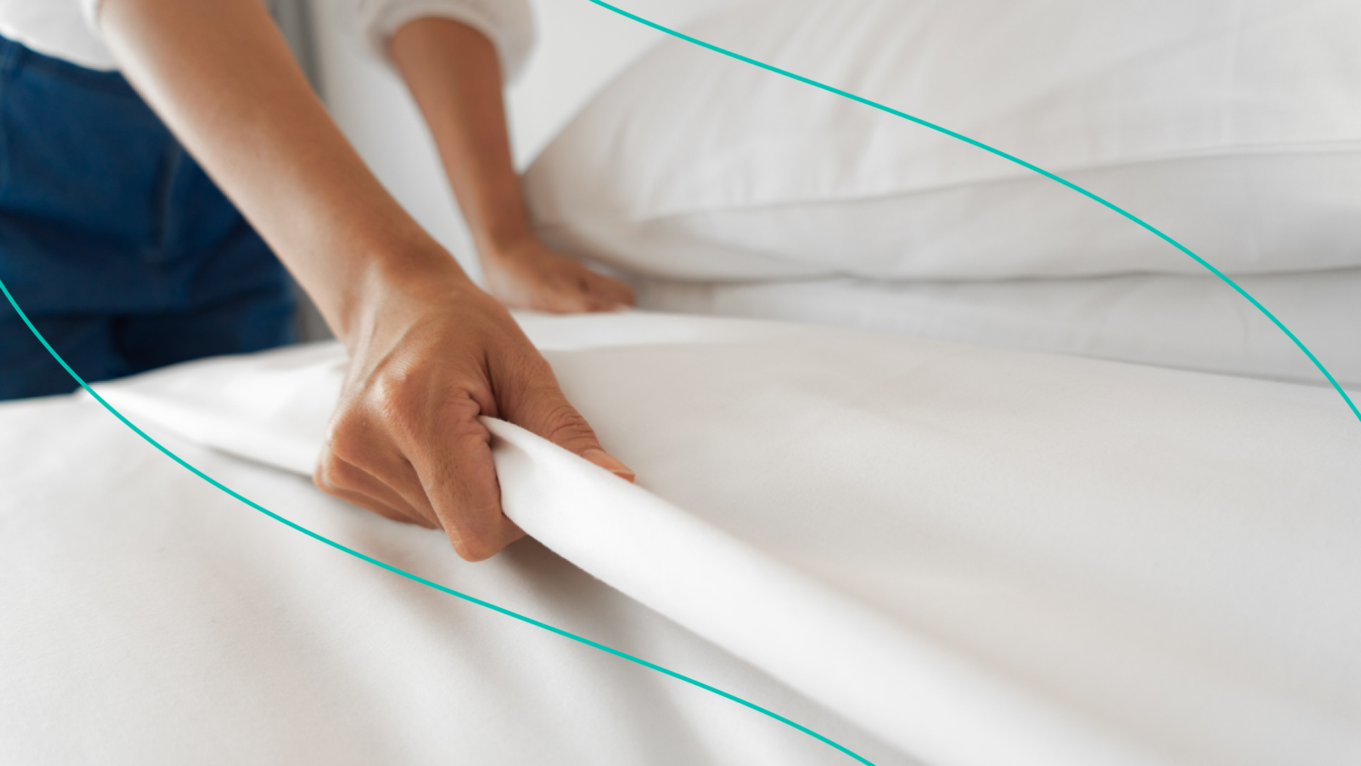 Person Fixing Sheets on Bed