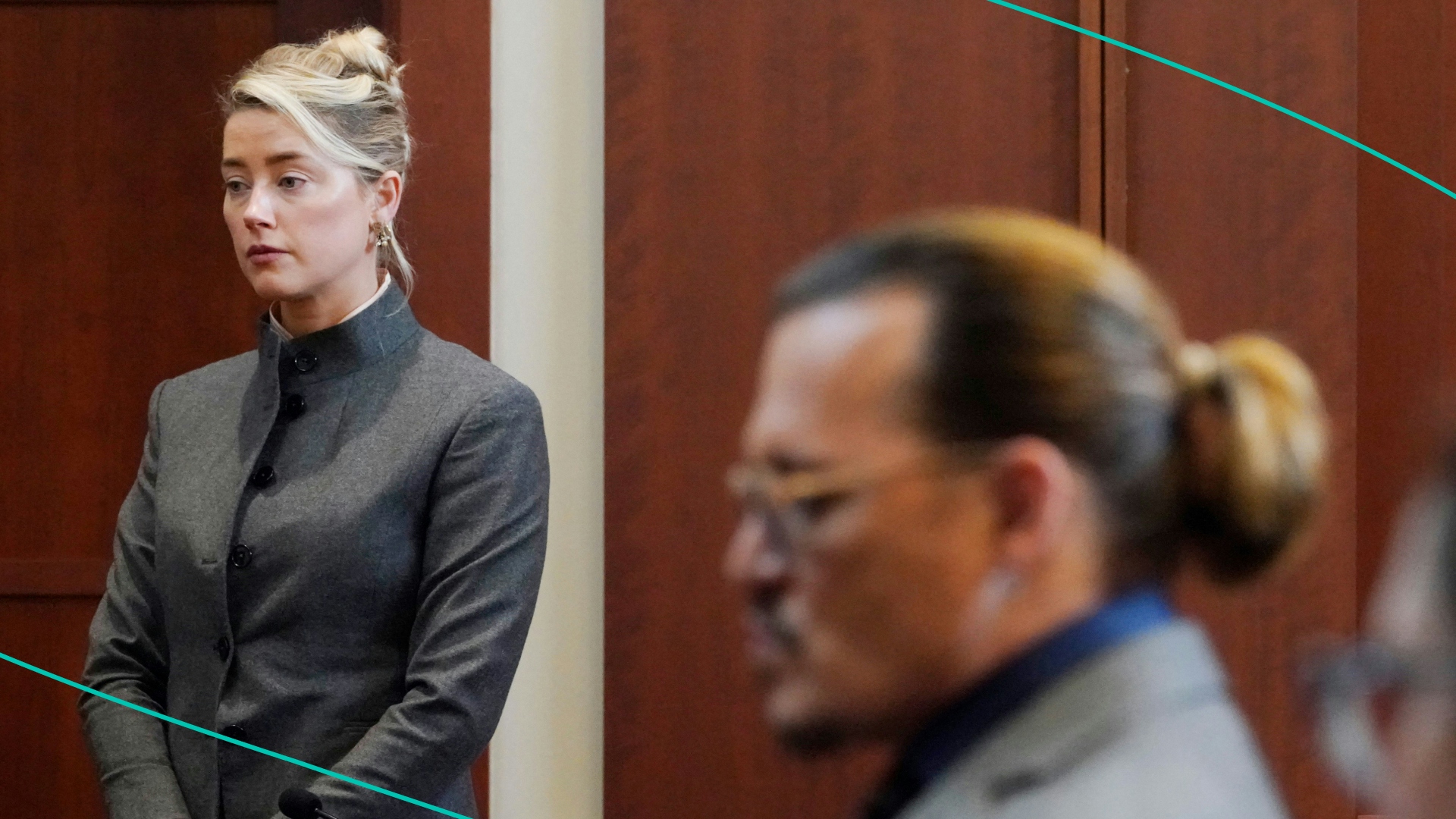Actors Amber Heard and Johnny Depp watch as the jury leave the courtroom for a lunch break at the Fairfax County Circuit Courthouse in Fairfax, Virginia, on May 16, 2022.