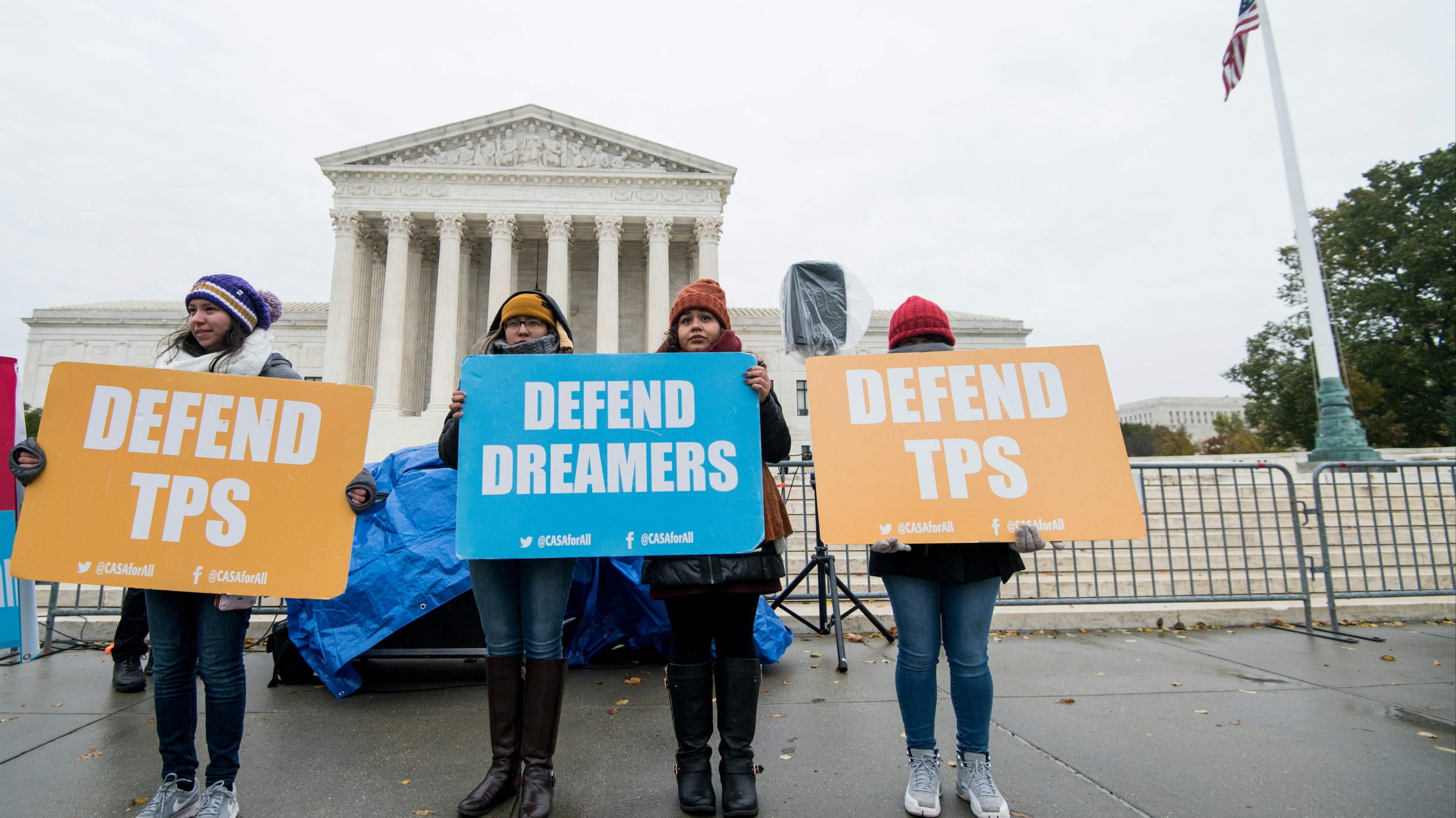 Protesters hold signs supporting dreamers and TPS outside of the U.S. Supreme Court 