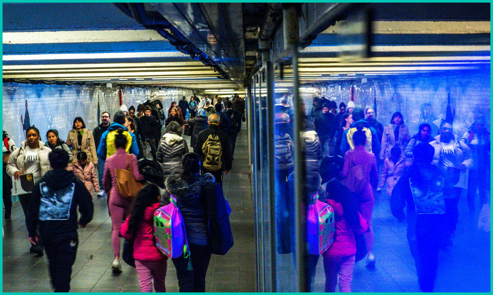 Commuters walk along the hallway at Times Square Subway station on March 6 2024. in New York City.