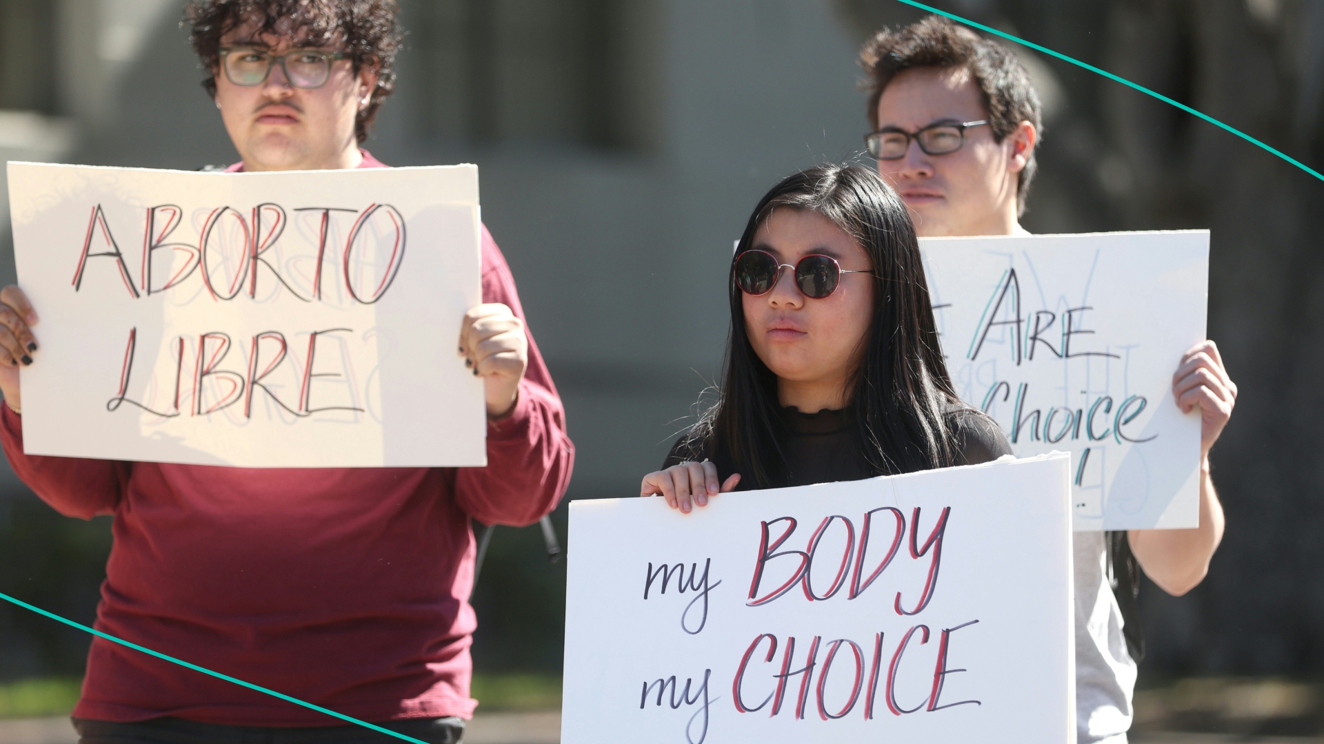 Demonstrators hold signs as they stage a protest in favor of abortion rights