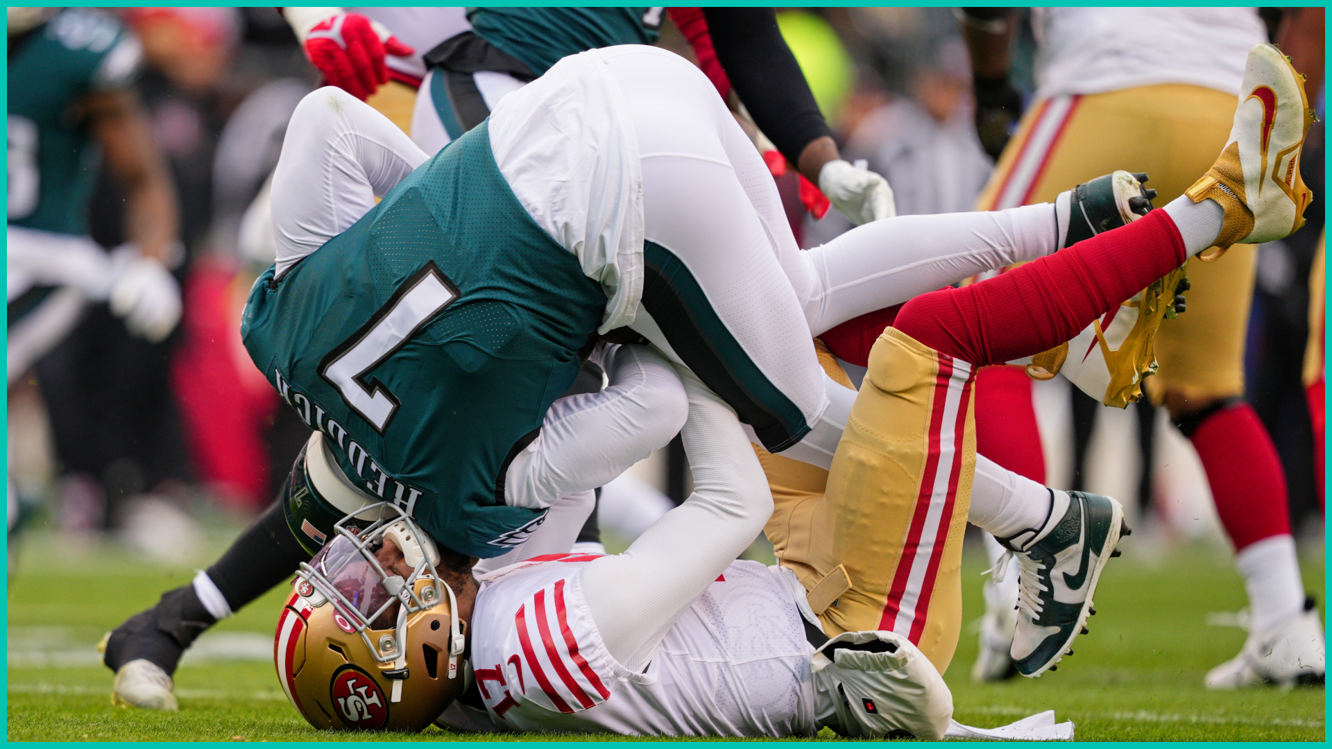 NFL Eagles player flipping over 49ers player during tackle