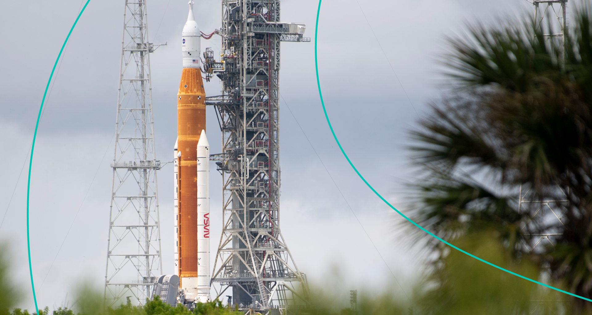 In this handout image provided by NASA, NASA's Space Launch System (SLS) rocket with the Orion spacecraft aboard is seen atop a mobile launcher