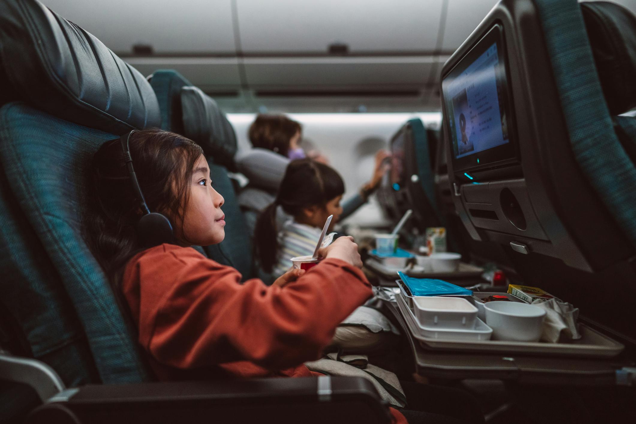 Little girl watching a movie on a flight