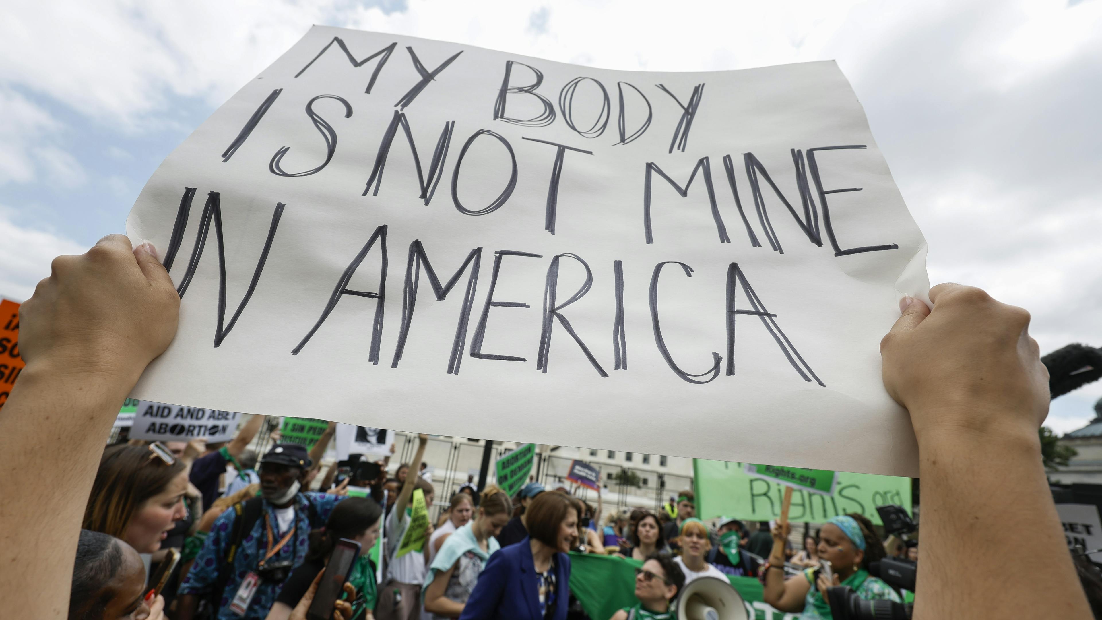 Poster that reads "My body is not mine in America"