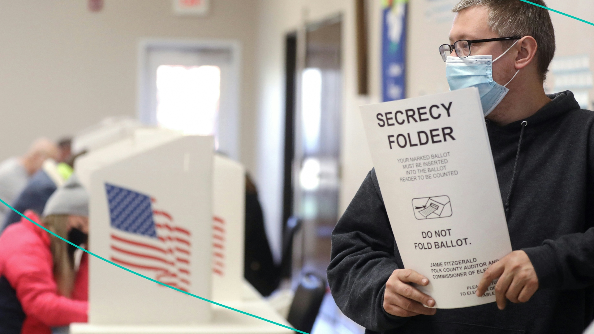 A poll worker holds a 'secrecy folder' used to conceal a voted ballot from view in a polling place at Bloomfield United Methodist Church on November 3, 2020 in Des Moines, Iowa.