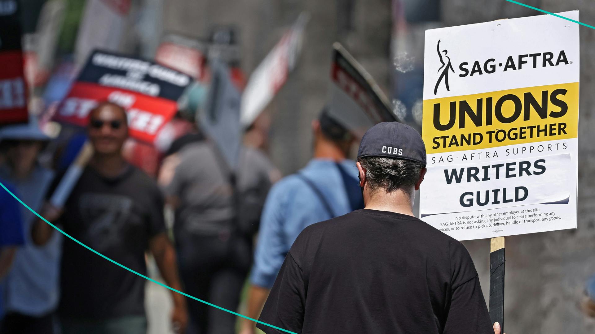 A sign reads 'Unions Stand Together' as SAG-AFTRA members walk the picket line in solidarity with striking WGA (Writers Guild of America) workers outside Netflix offices on July 11, 2023 in Los Angeles, California.