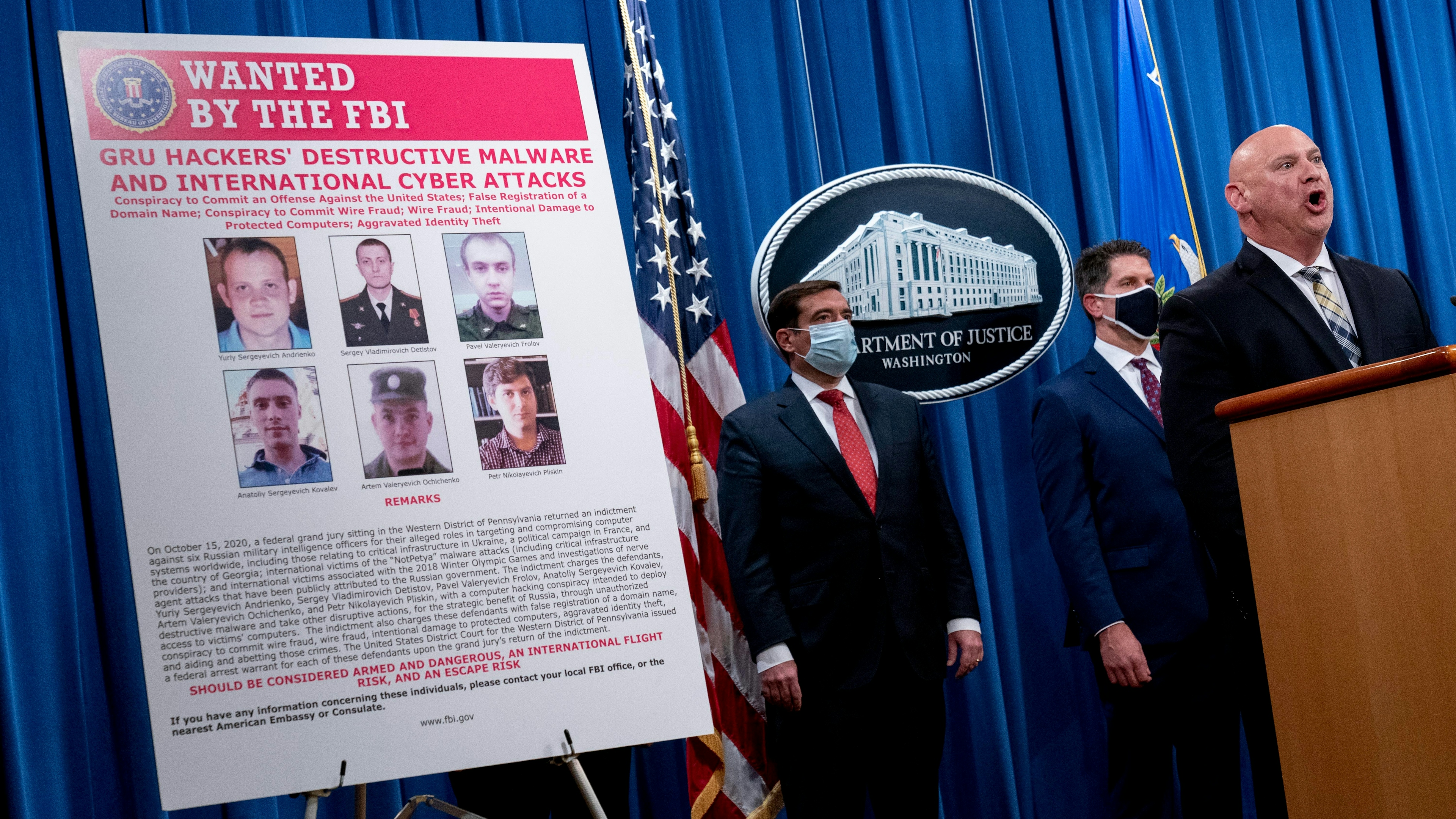 A poster showing six wanted Russian military intelligence officers is displayed
