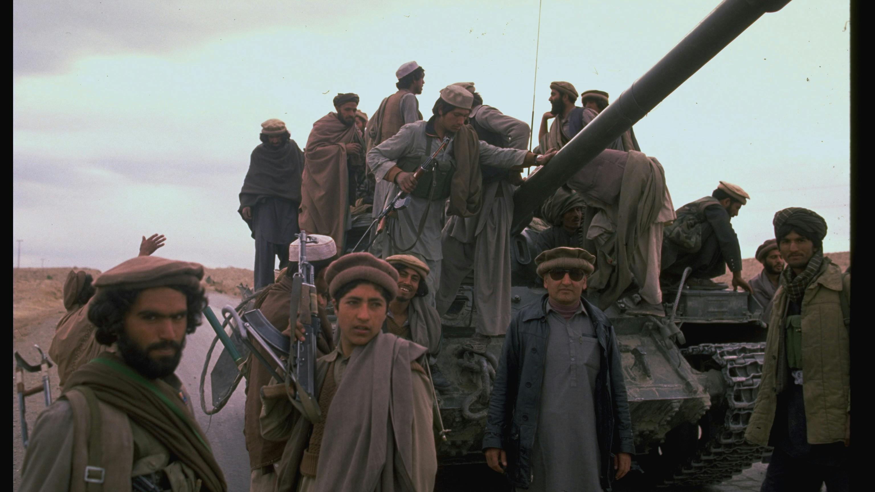 Mujahideen during rebel assault on Jalalabad: w. captured Soviet T 55 tank.