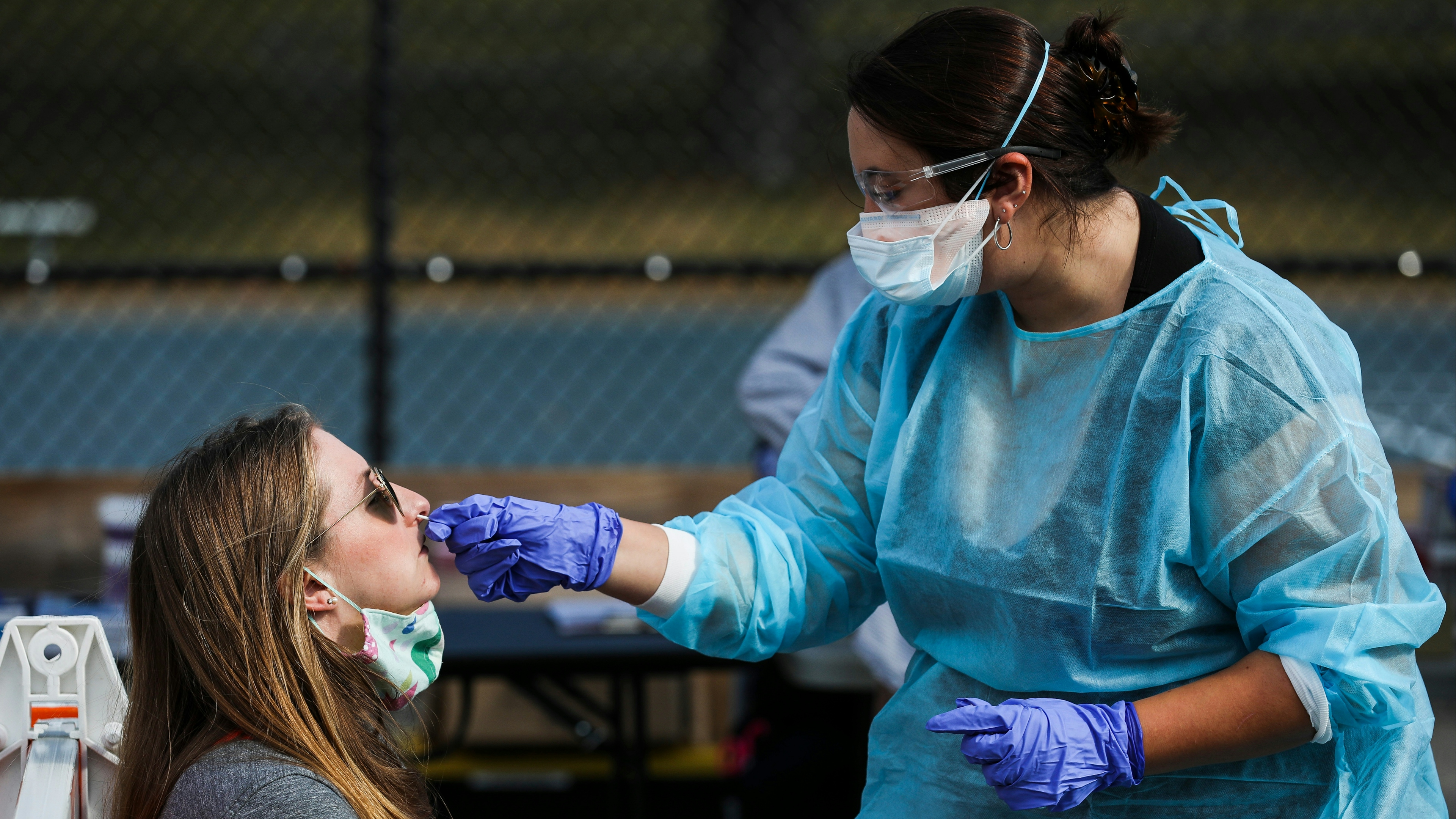 A woman has her nose swabbed at a Stop the Spread COVID-19 testing site in Massachusetts.
