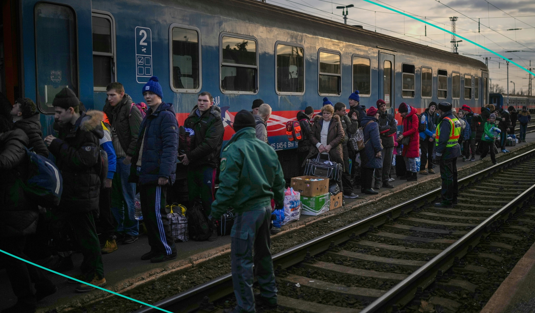 Ukrainian refugees waiting outside of a train