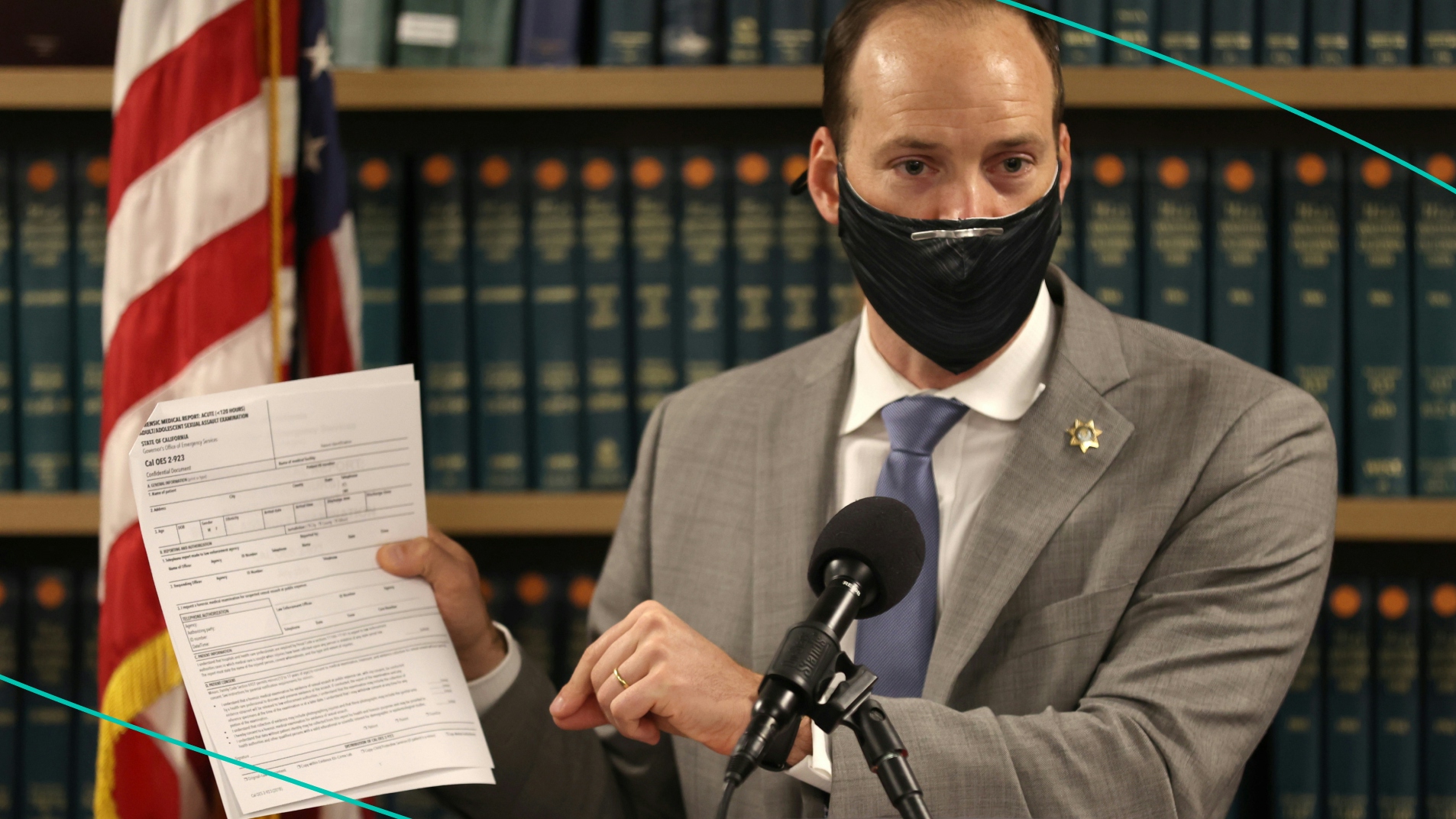 San Francisco District Attorney Chesa Boudin holds up a copy of the California State medical examination form for sexual assault victims as he speaks during a press conference at his office on February 15, 2022 in San Francisco, California.
