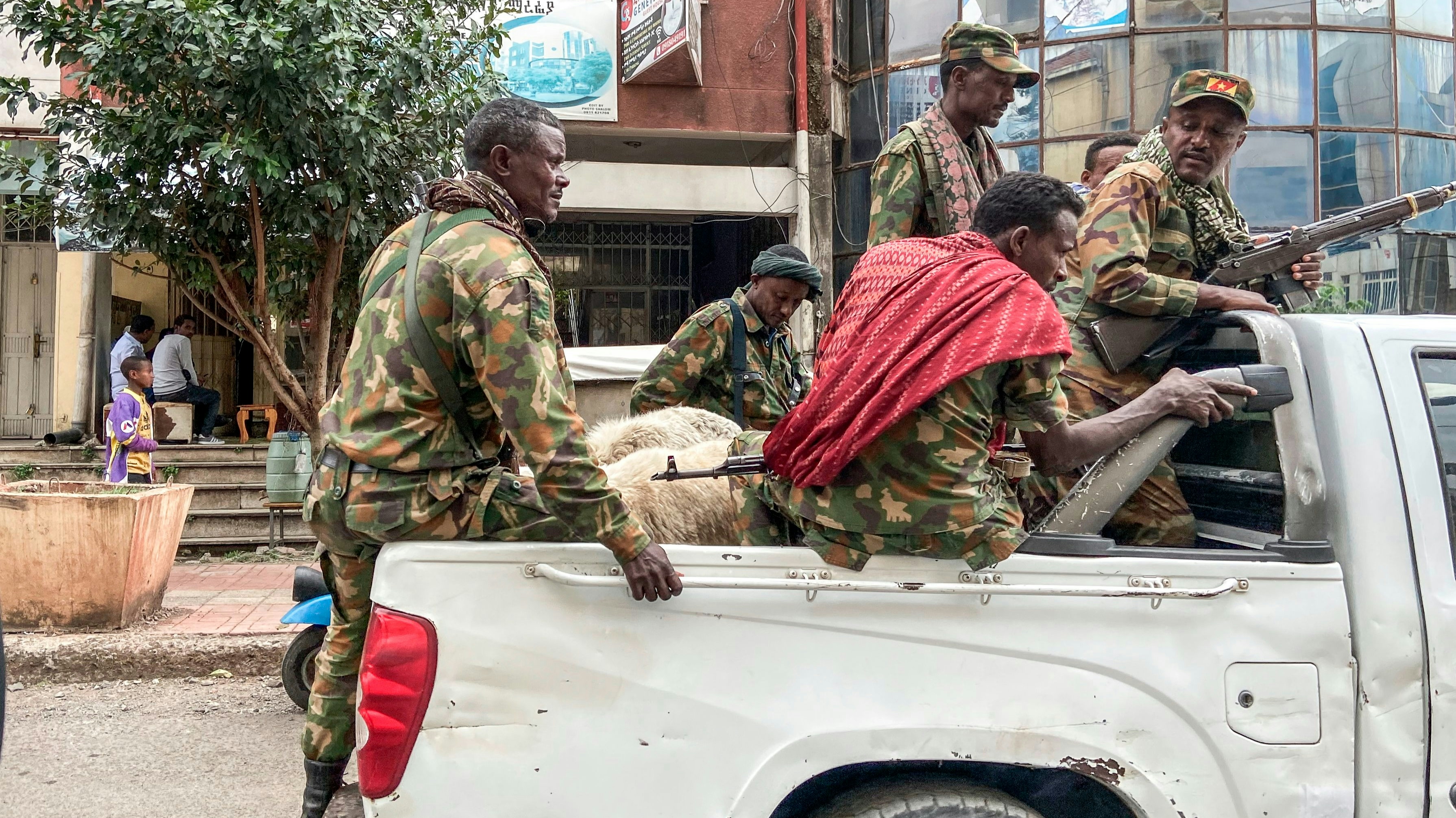 Members of the Amhara militia, that combat alongside federal and regional forces against northern region of Tigray, ride on the back of a pick up truck in the city of Gondar, on 08 November 2020. 