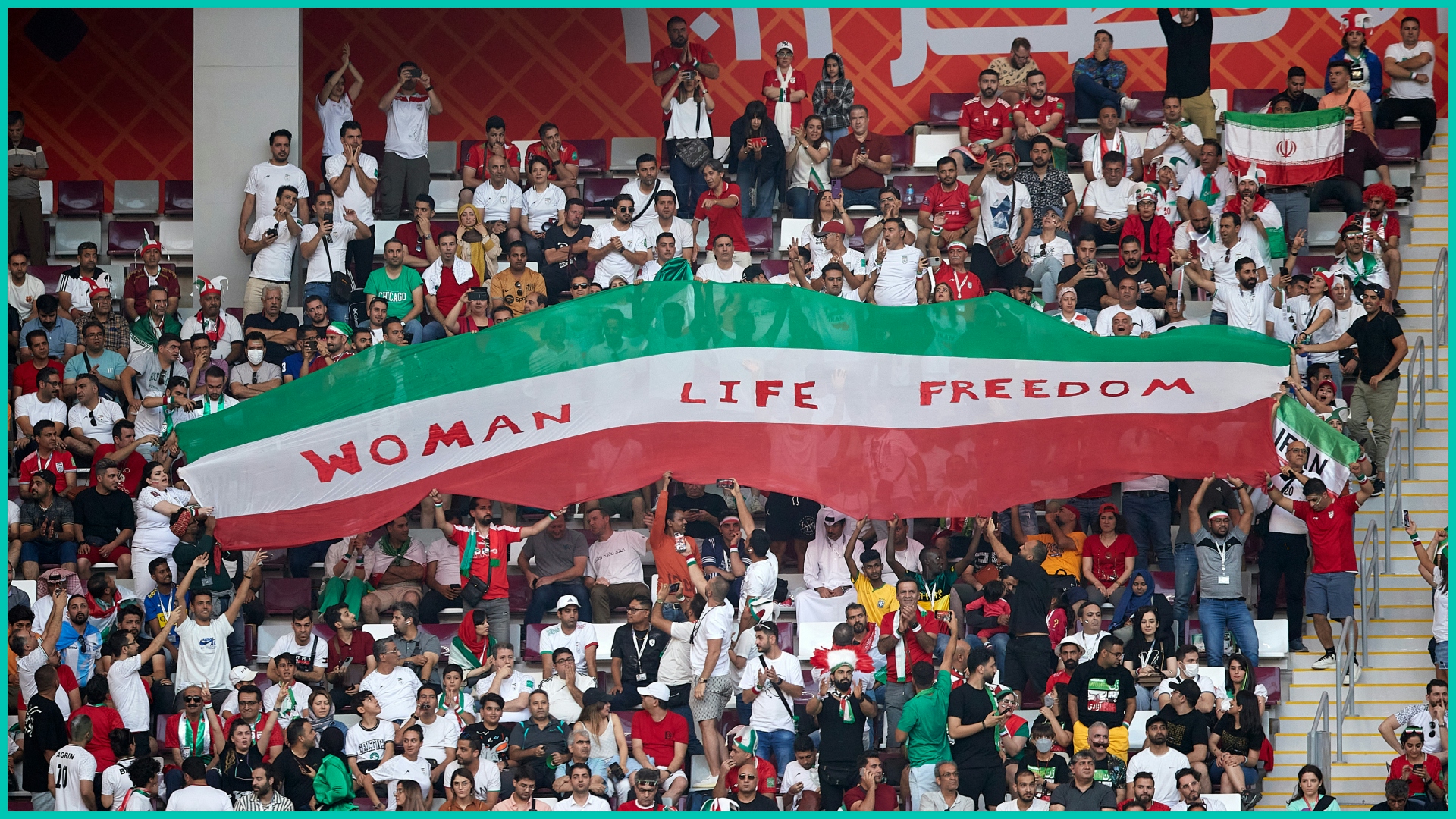 Iranian fans hold up signs "Woman Life Freedom" during the FIFA World Cup Qatar 2022
