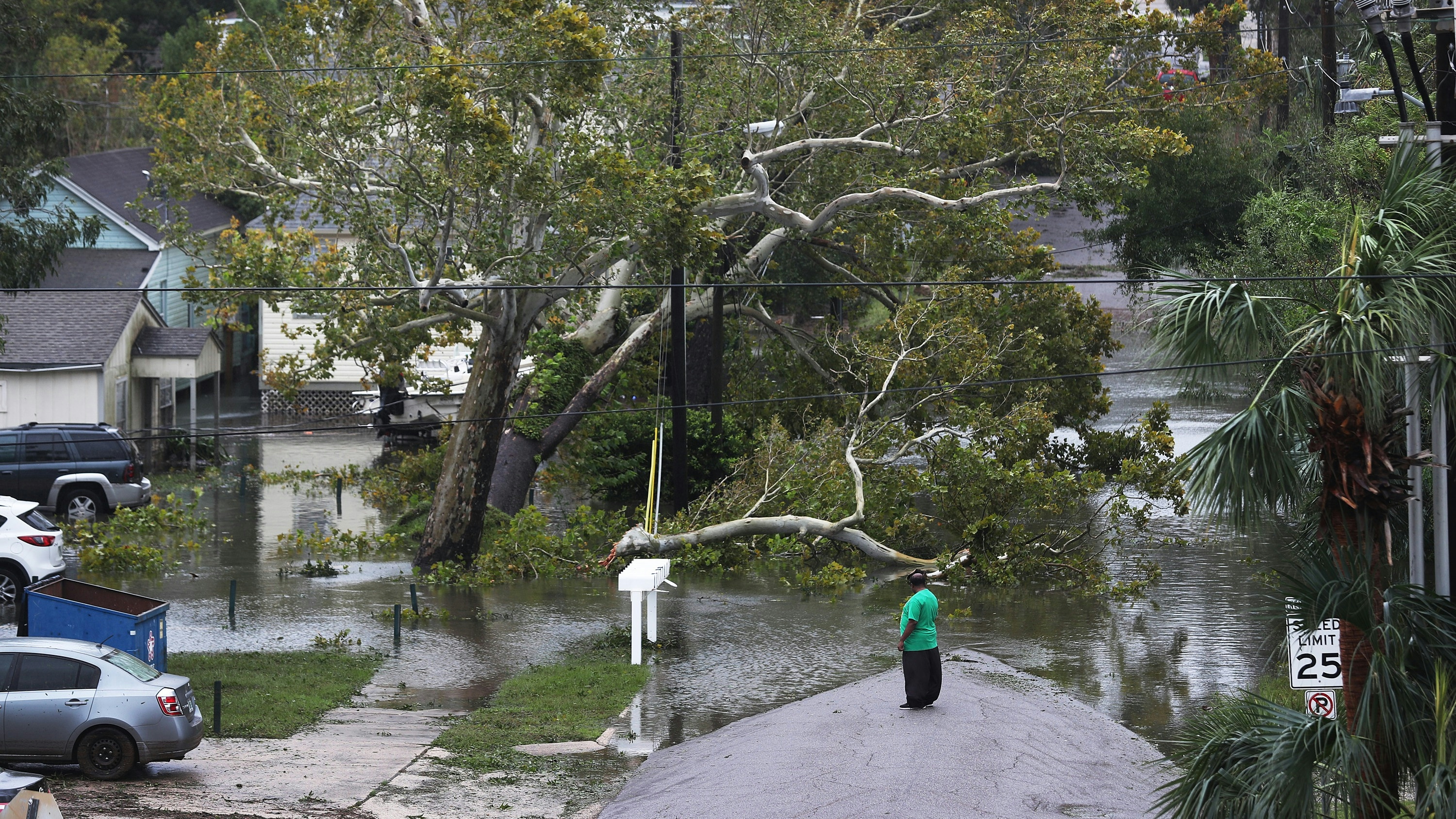 A person looks at a flooded neighborhood as Hurricane Sally passes through Pensacola, FL