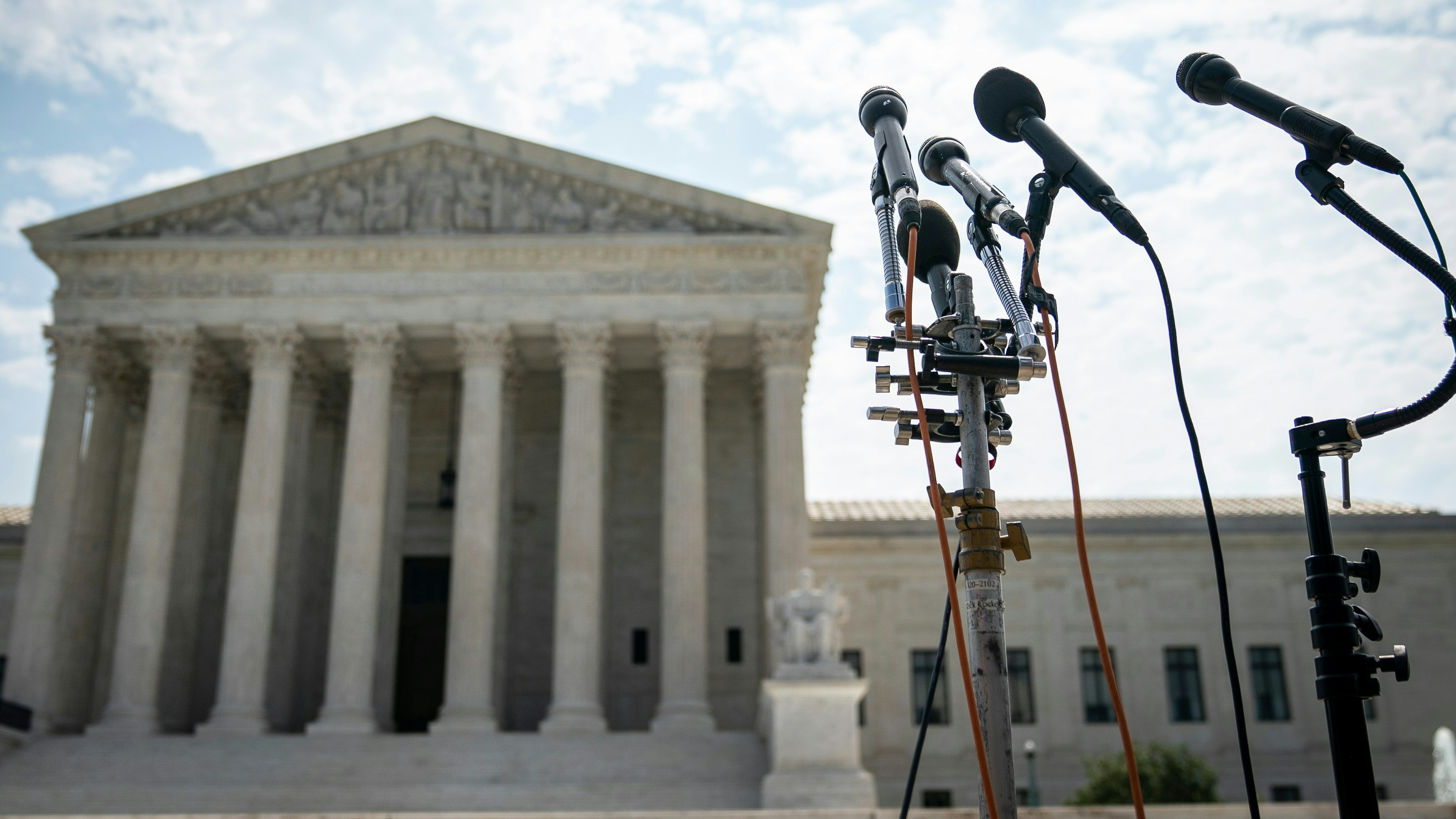 A set of microphones stand outside of the U.S. Supreme Court on July 6, 2020