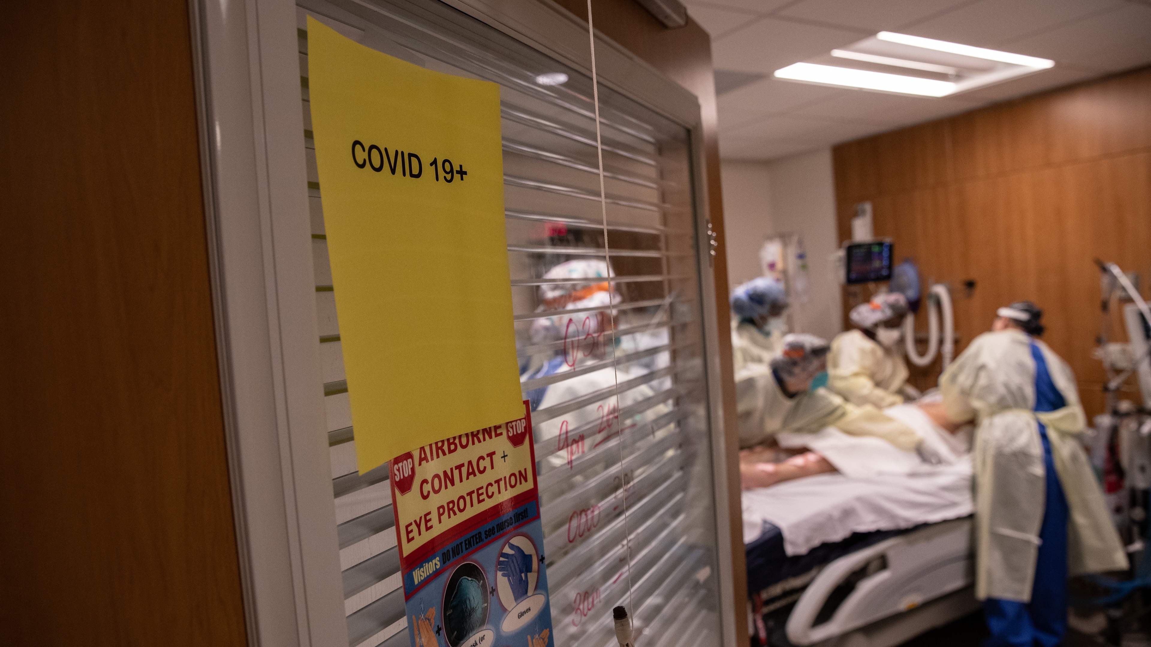 A "prone team," wearing personal protective equipment (PPE), prepares to turn a COVID-19 patient onto his stomach in a Stamford Hospital intensive care unit (ICU), on April 24, 2020 in Stamford, Connecticut.