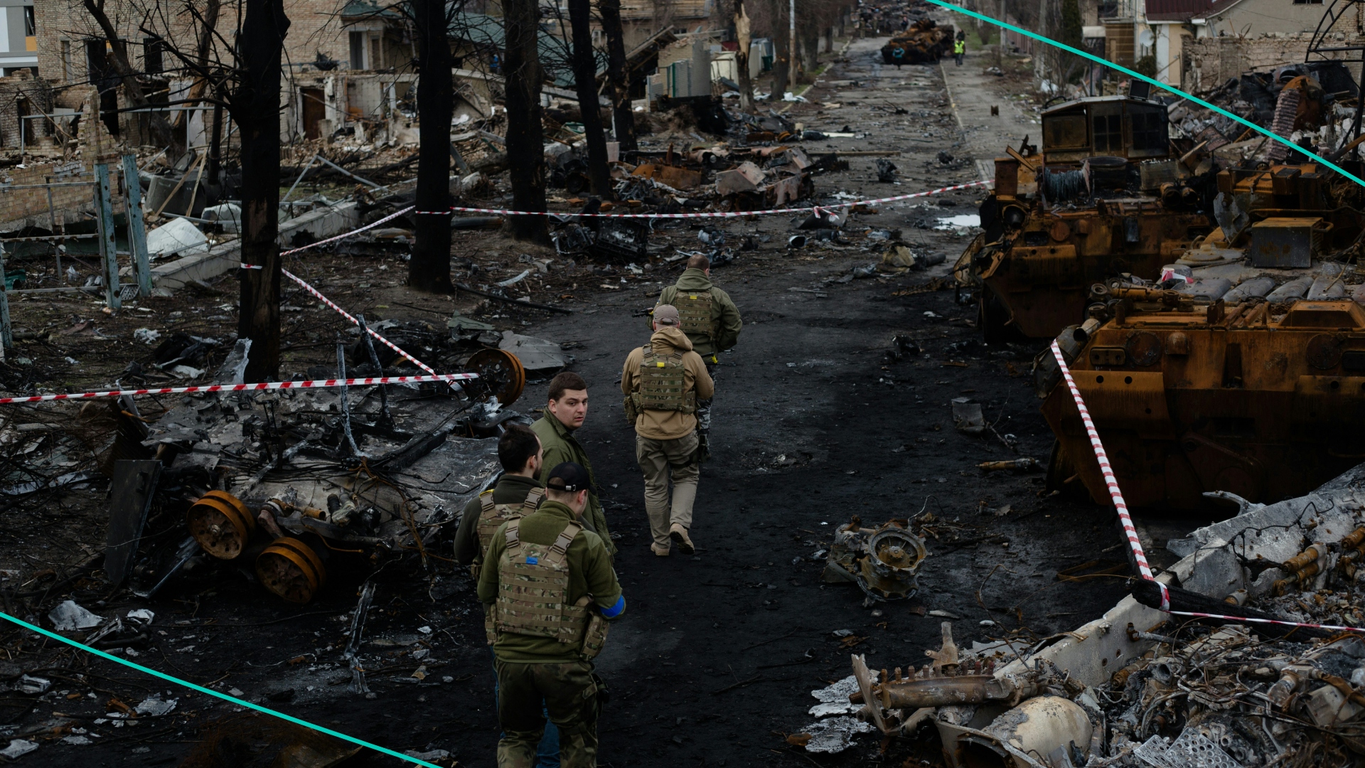 Ukrainian servicemen walk on the destroyed street on April 4, 2022 in Bucha, Ukraine