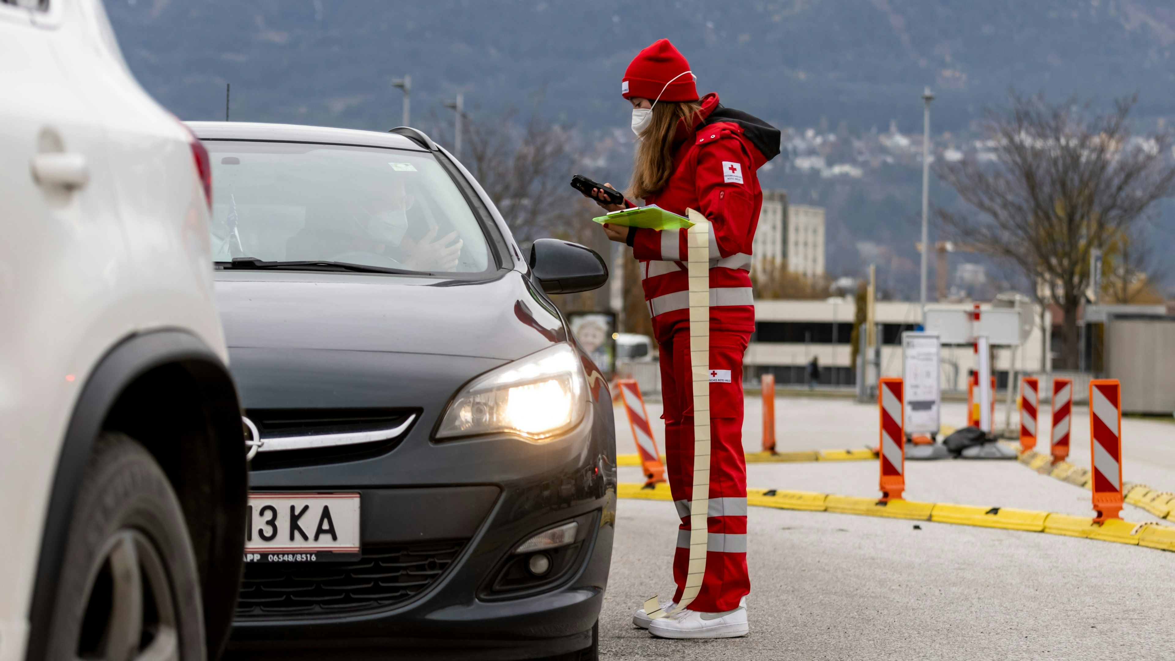 An employee of the Red Cross checks the registrations for the PCR test at a Covid-19 testing station on November 08, 2021 in Innsbruck, Austria