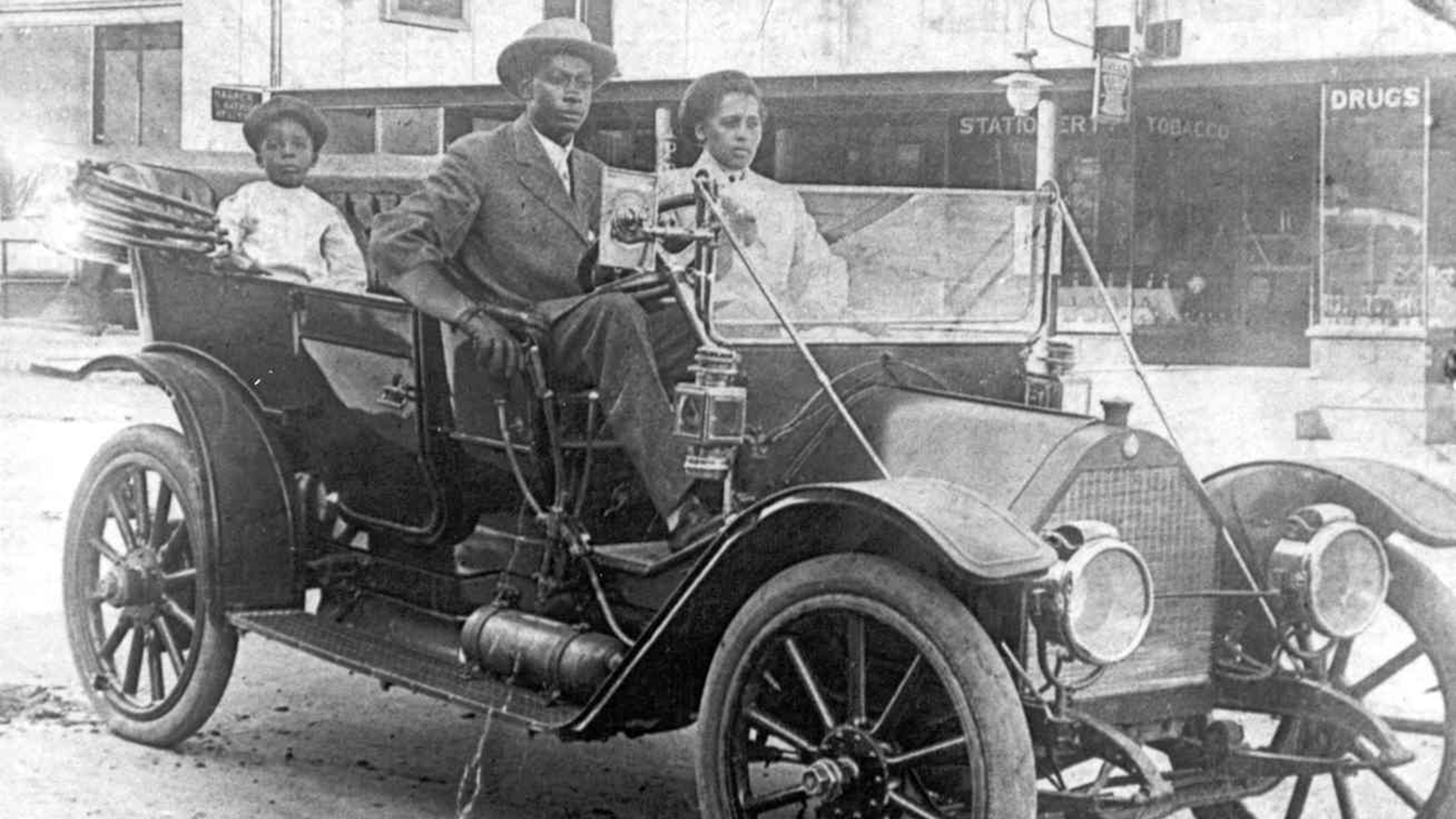 View of American businessman John Wesley Williams sits in his car with wife Loula Williams and their son, WD Williams, Tulsa, Oklahoma, 1910s