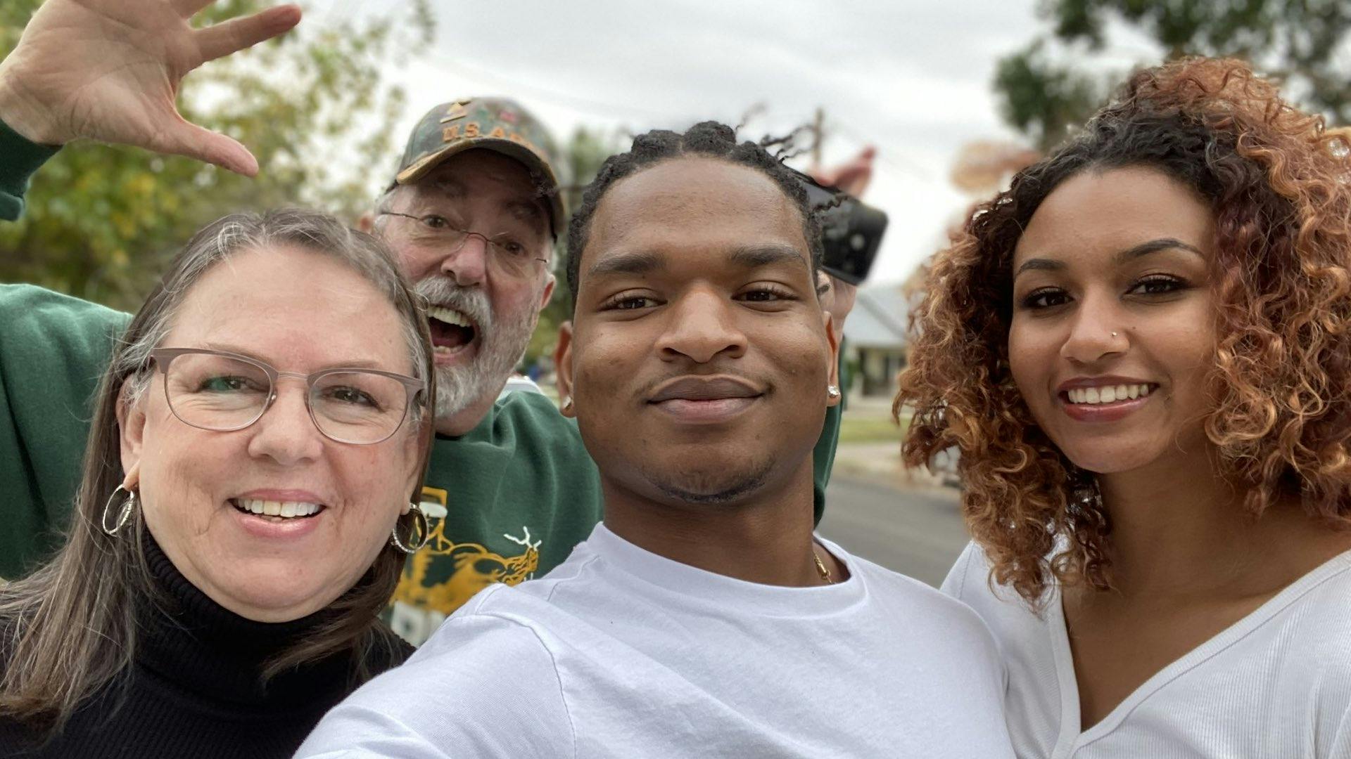 Jamal Hinton celebrating Thanksgiving in 2021 with his girlfriend, Wanda Dench, and Dench’s husband.
