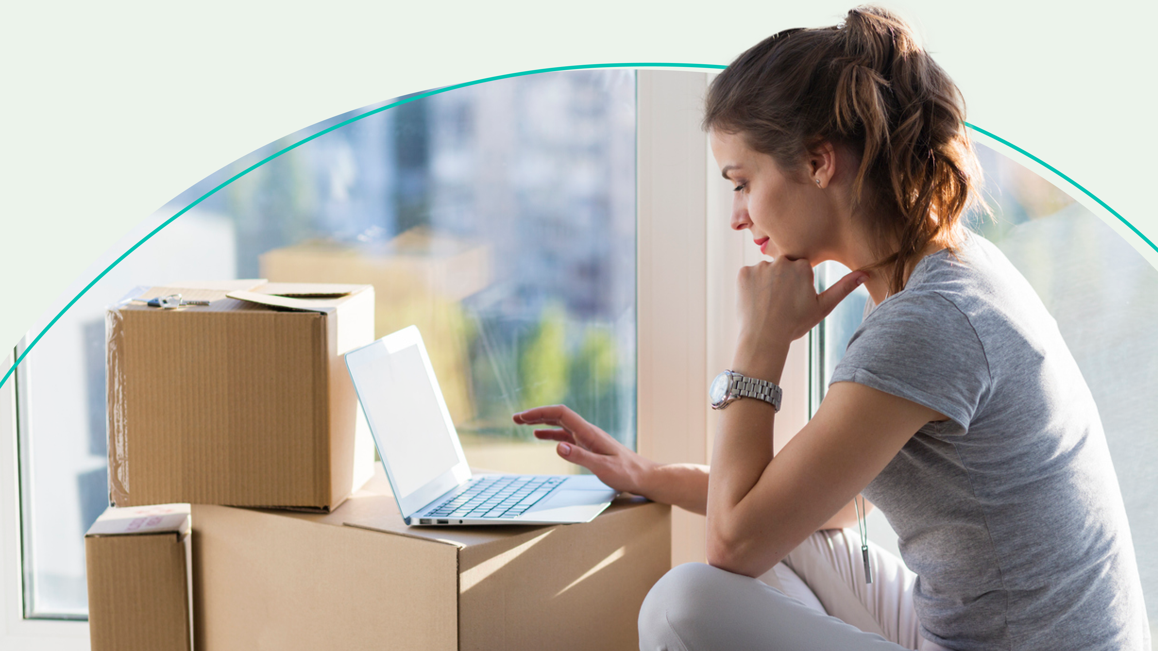 A woman on a laptop during a move