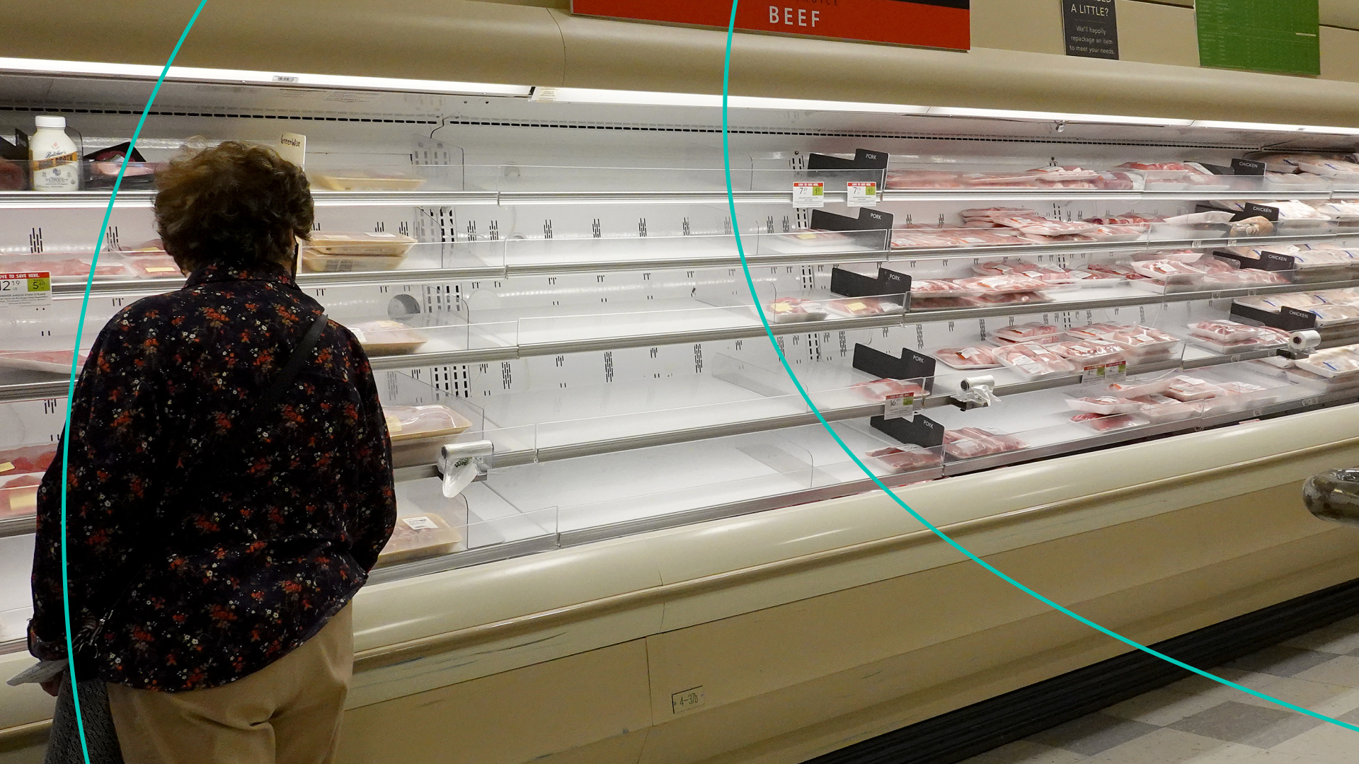 Shelves displaying meat are partially empty as shoppers makes their way through a supermarket