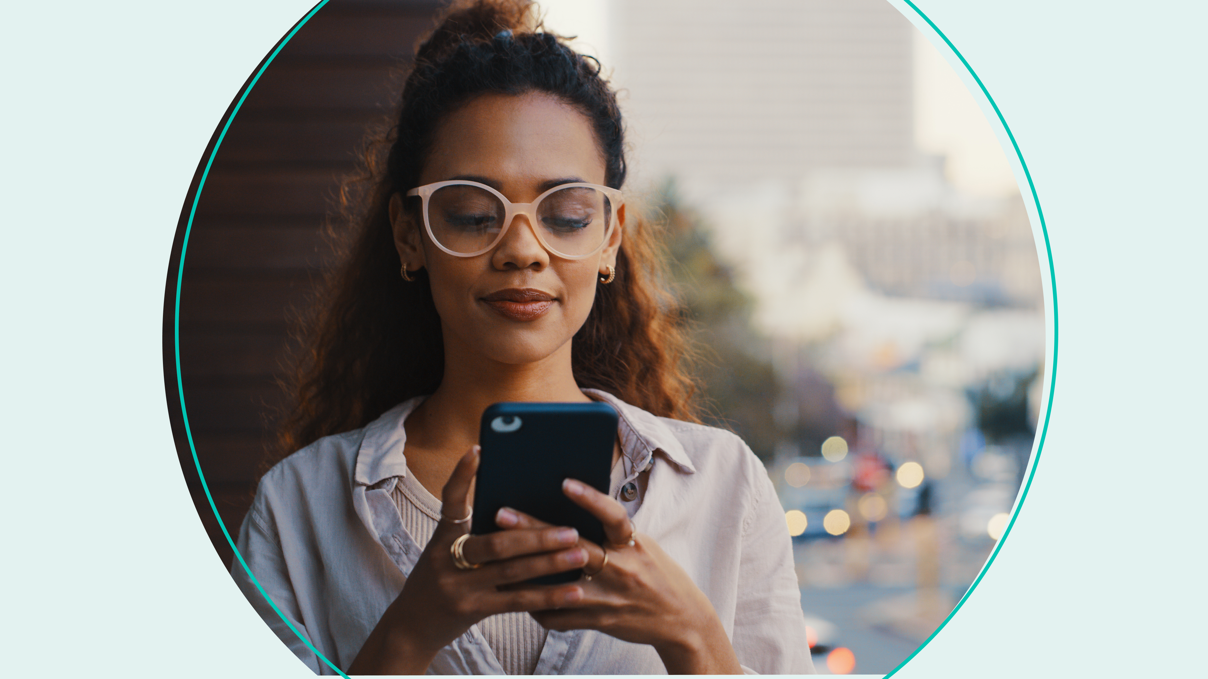 woman with big glasses looking at phone outside stock photo