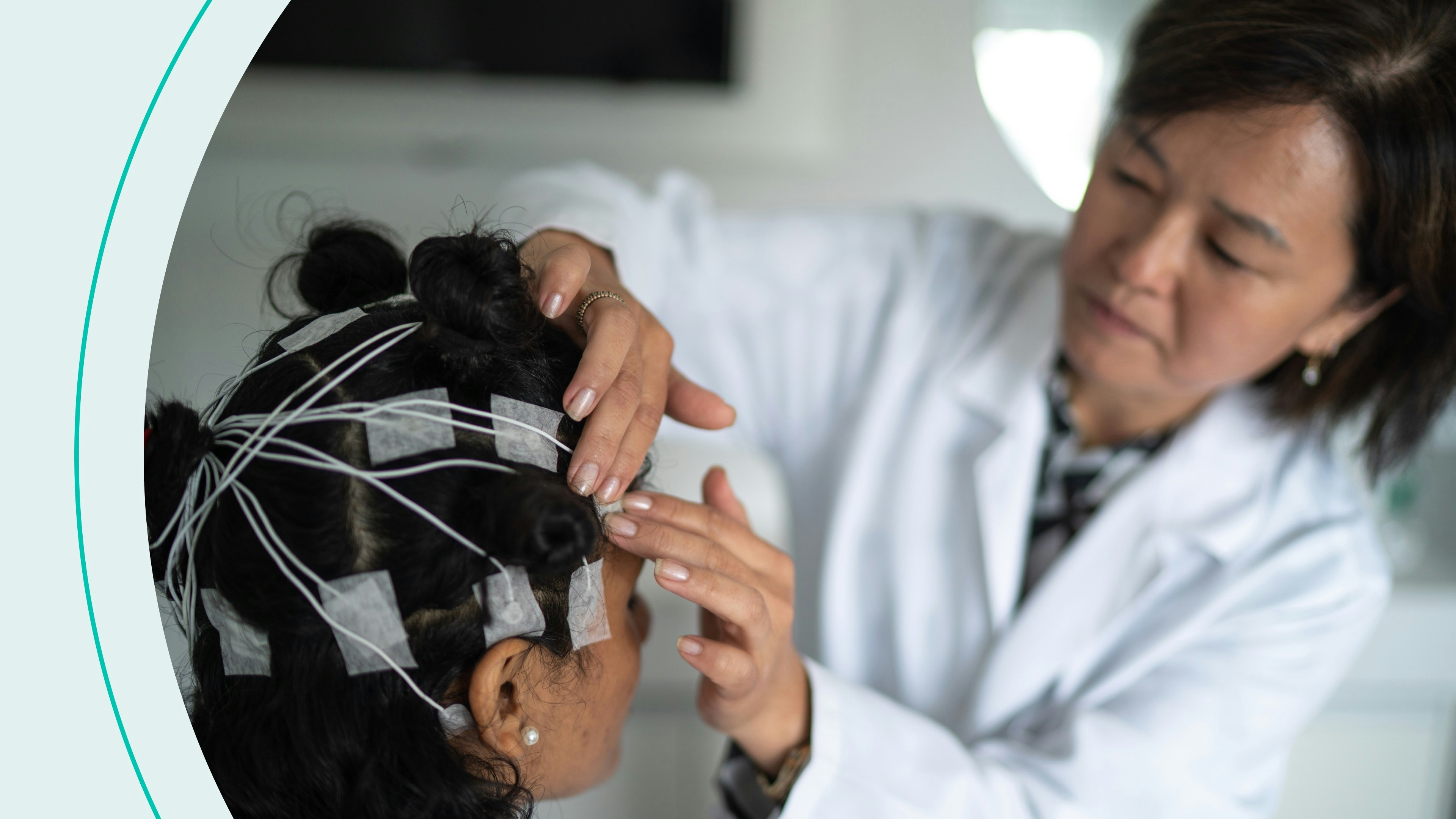 A doctor applying electrodes to a woman's head