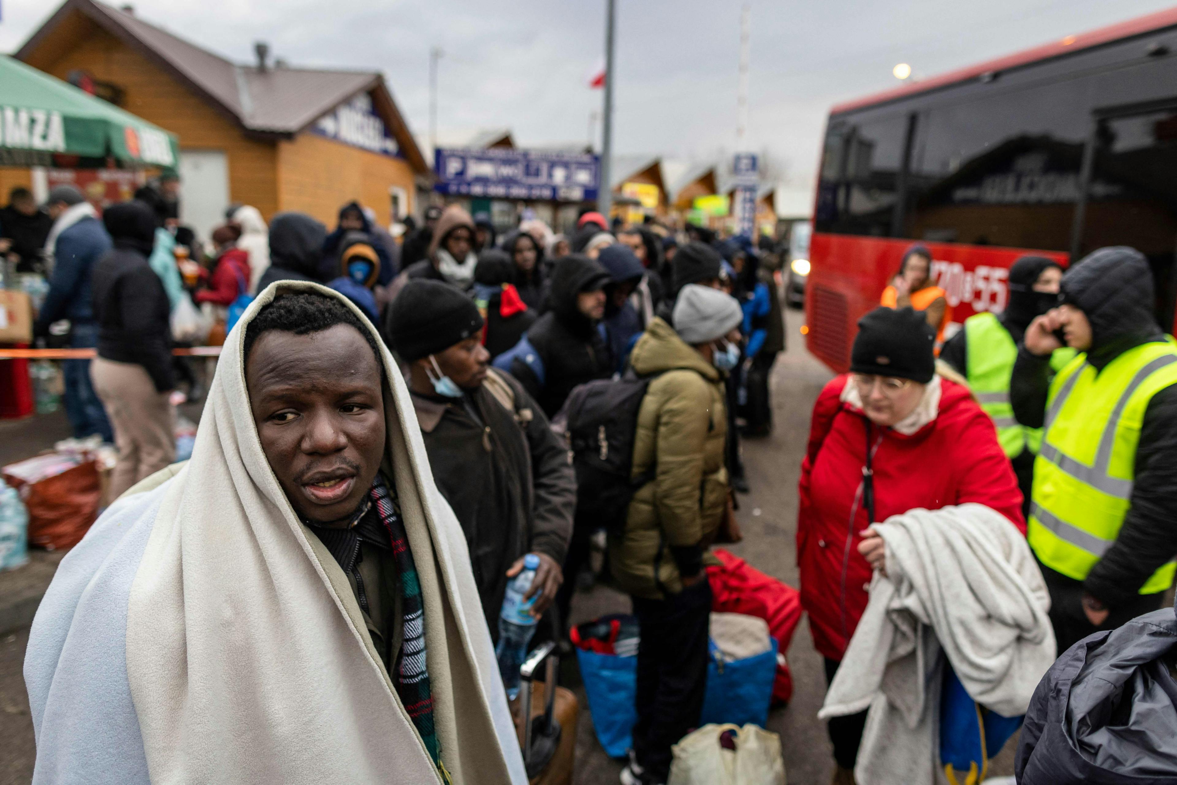 Ukrainian refugees waiting to get on a bus.