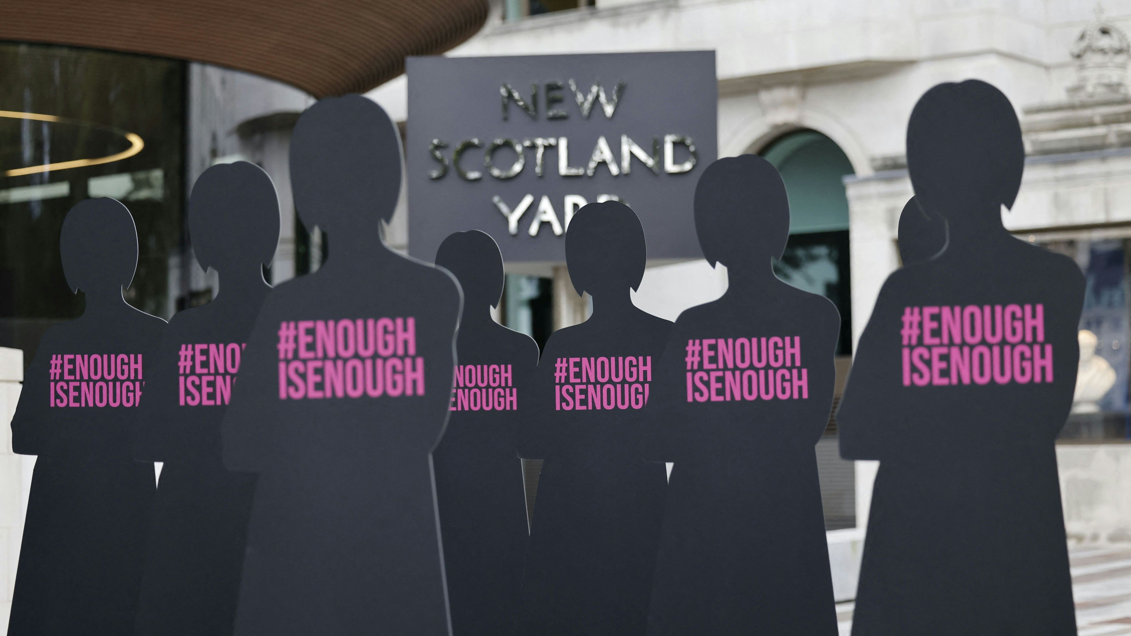 Cut-out silhouettes representing women are set up outside the Metropolitan Police headquarters