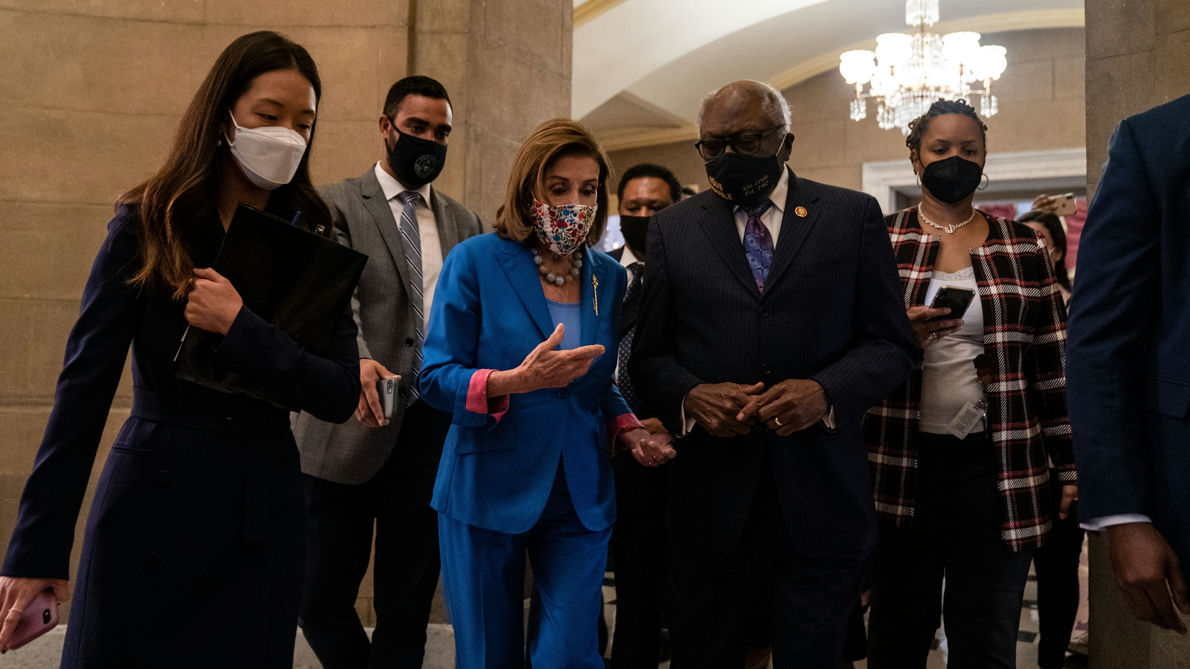 Speaker of the House Nancy Pelosi (D-CA) returns to her office, while she talks with Rep. James Clyburn